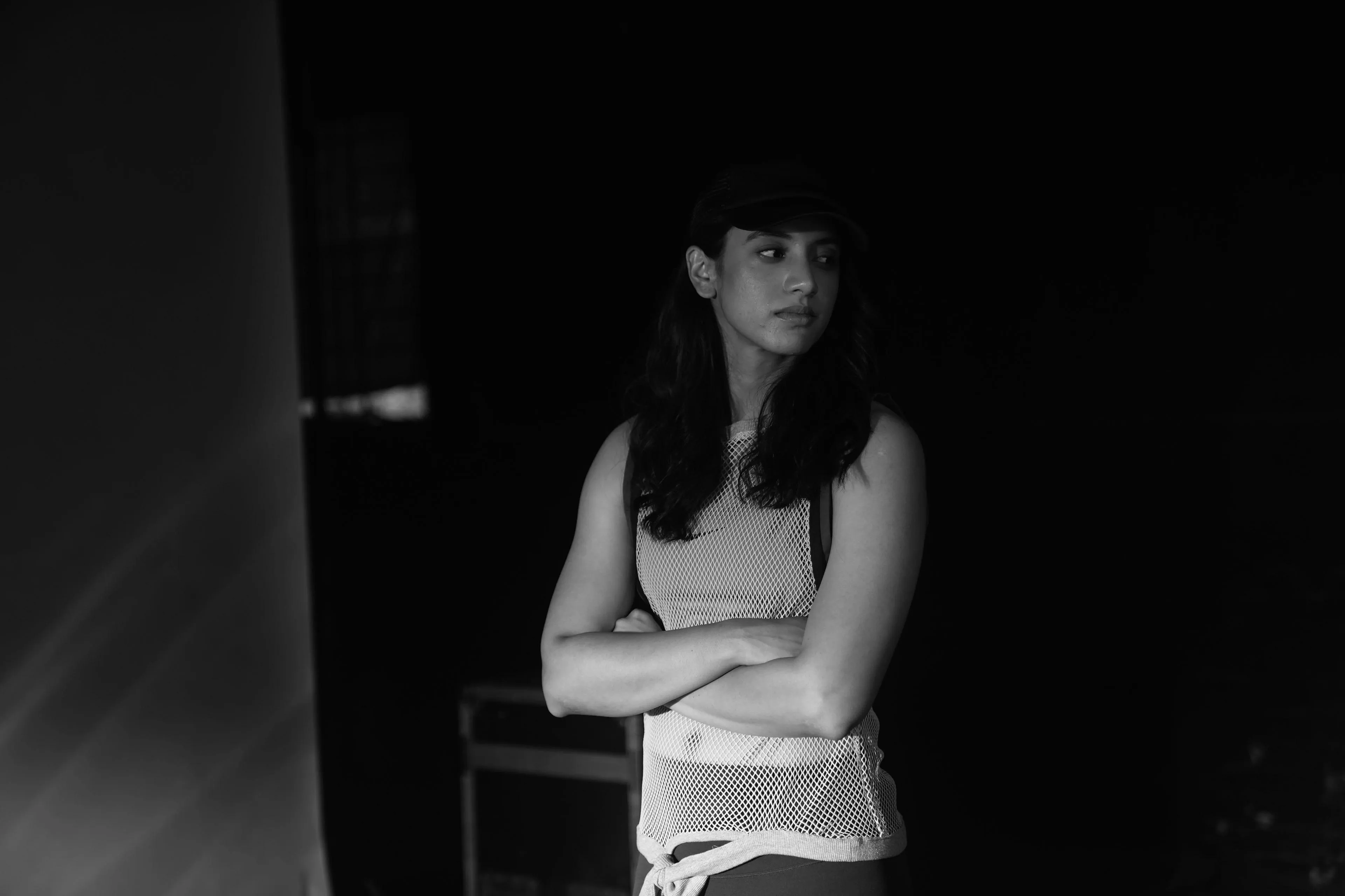 Black and white photo of Smriti Mandhana in spotlight