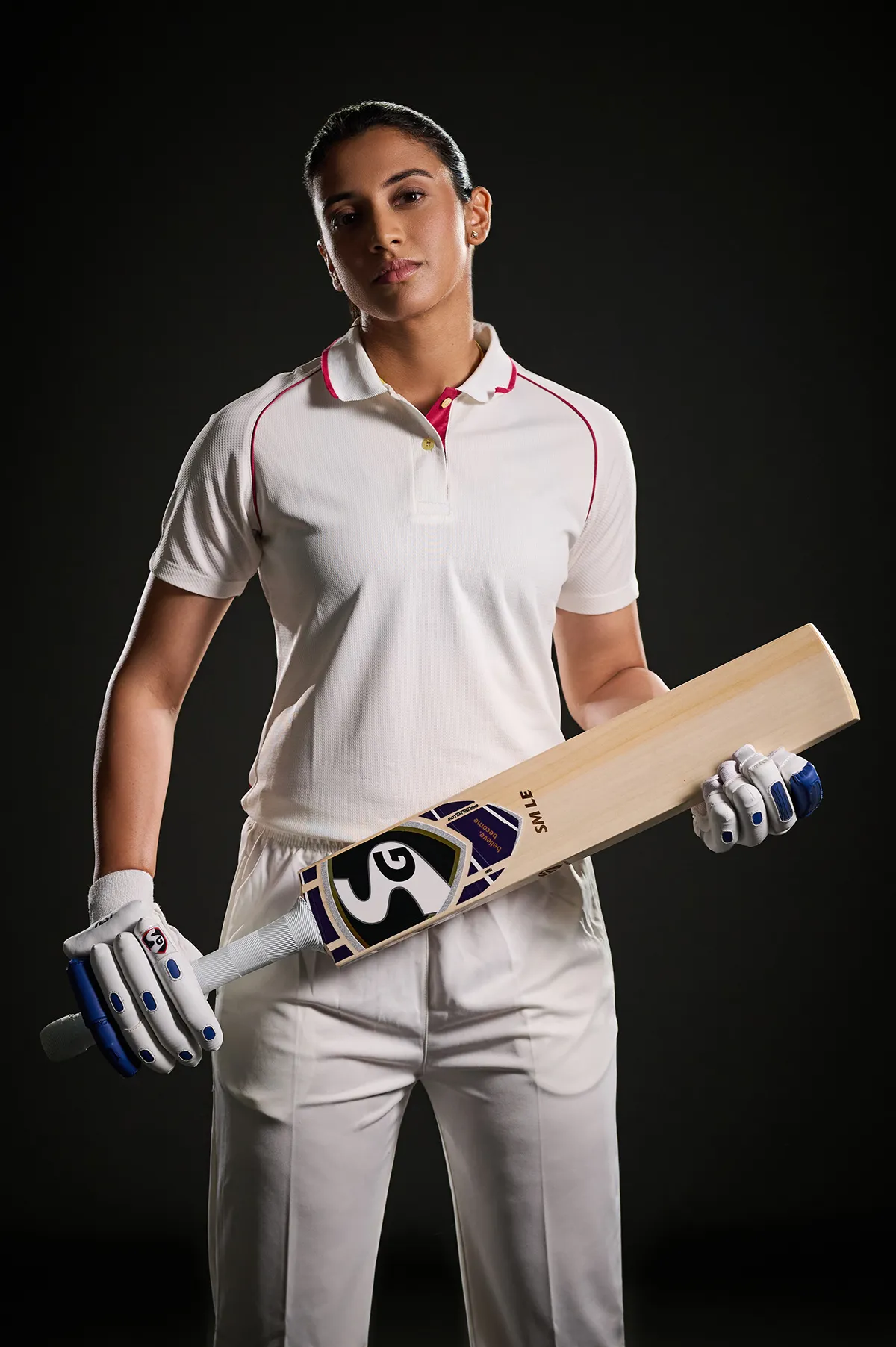 Confident cricketer posing with bat in studio wallpaper
