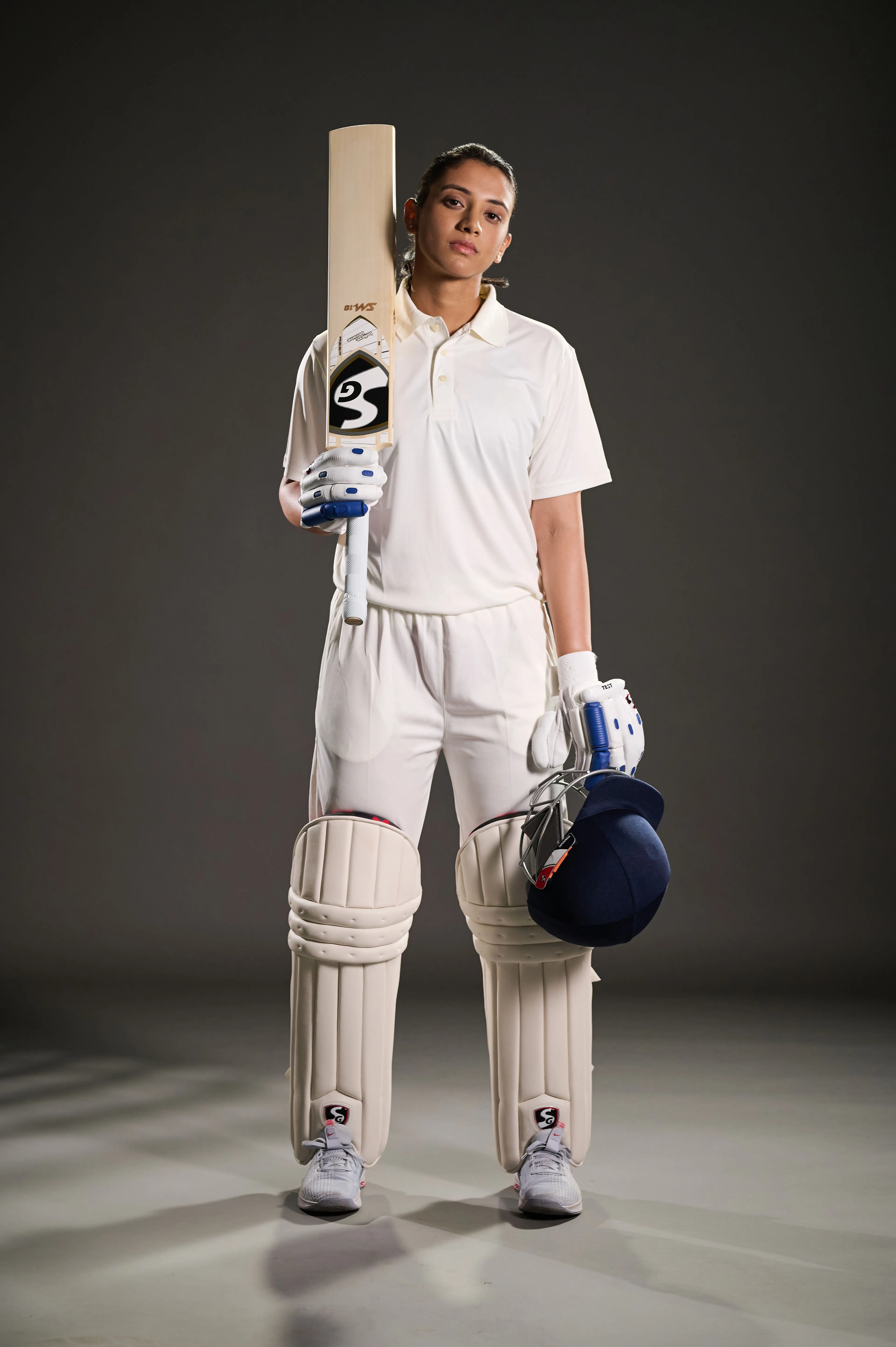 Cricketer poses confidently in full white test uniform