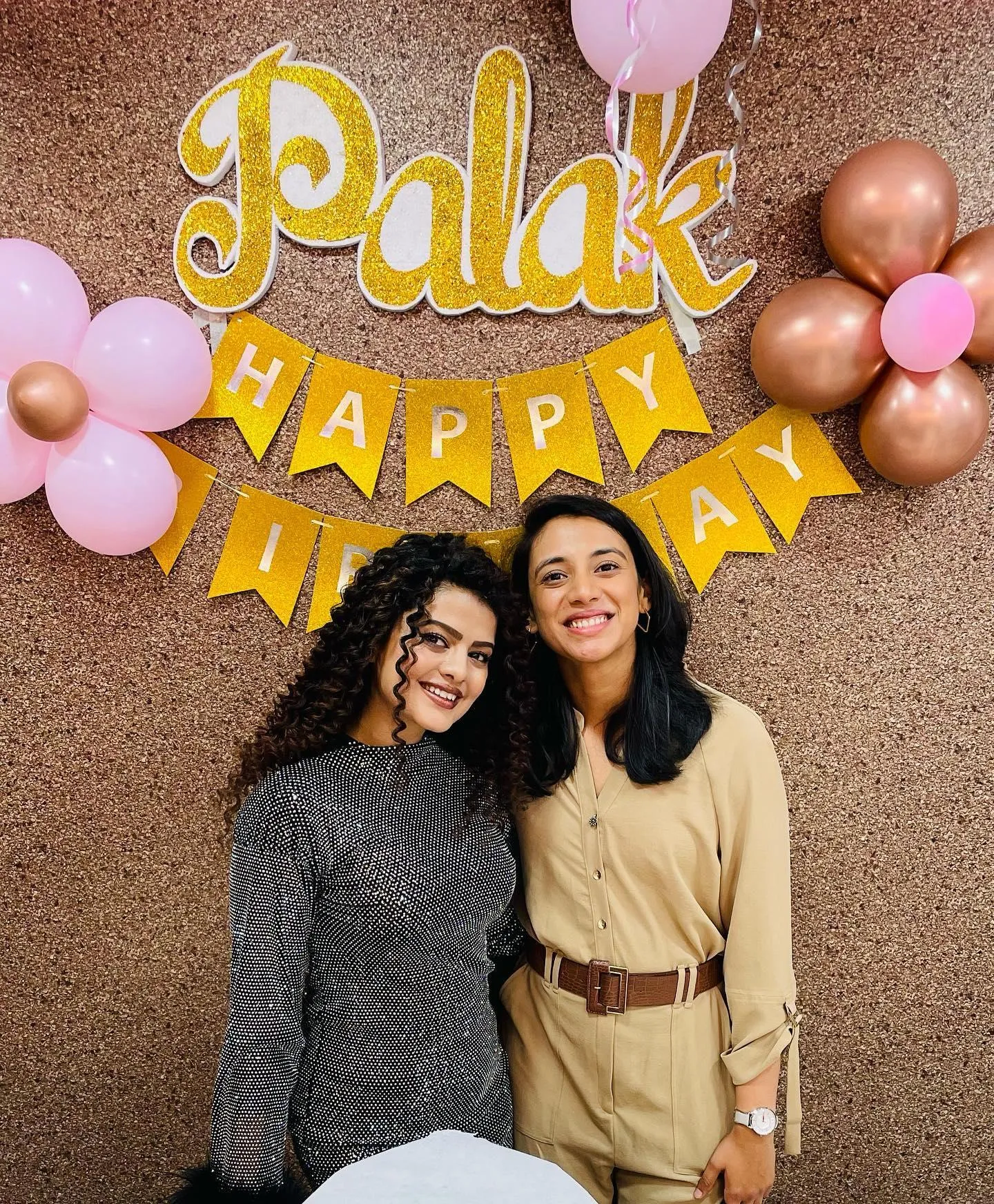 Smiling in front of colorful birthday balloons wallpaper