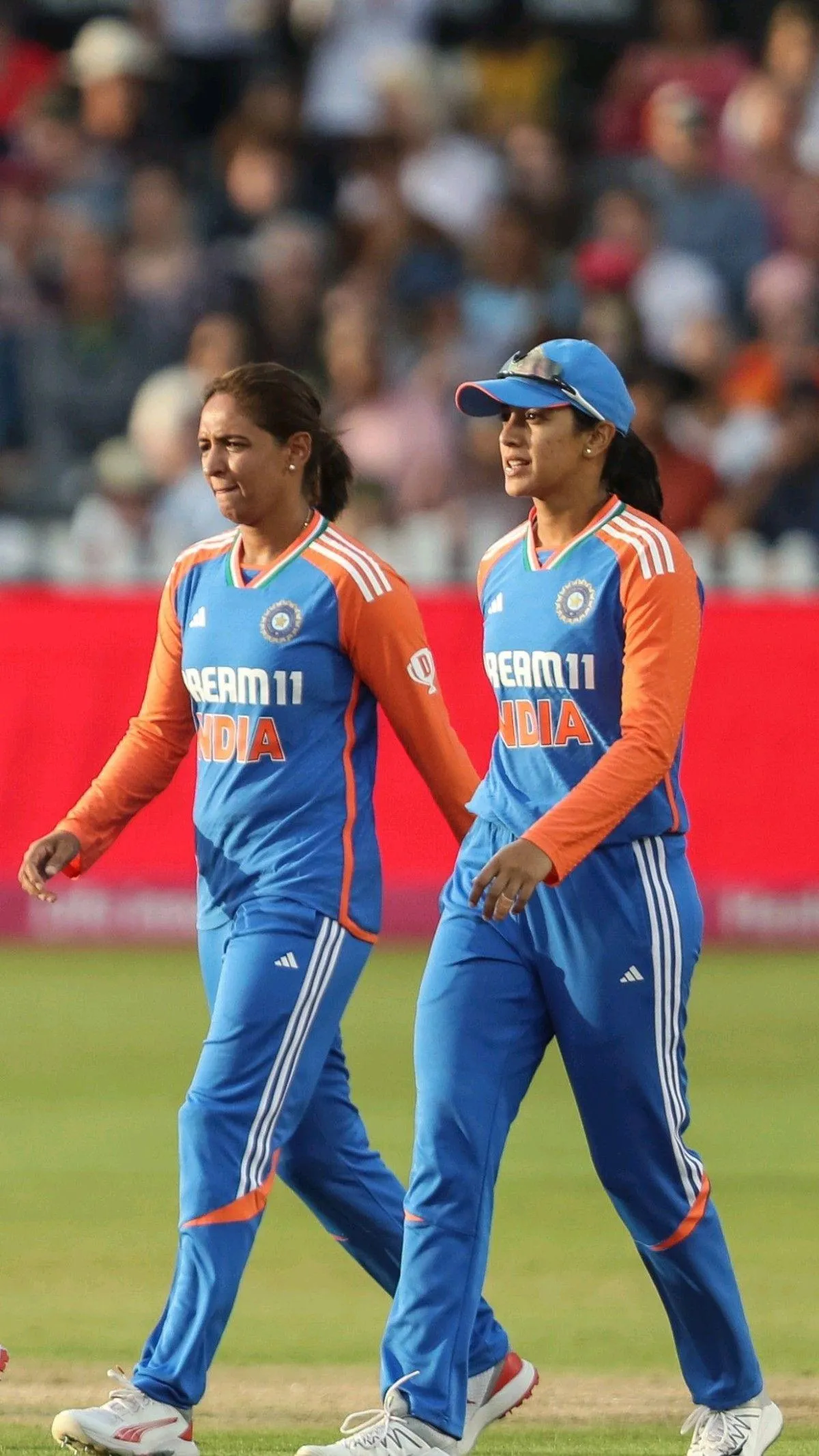 Smriti and teammate celebrating during cricket match