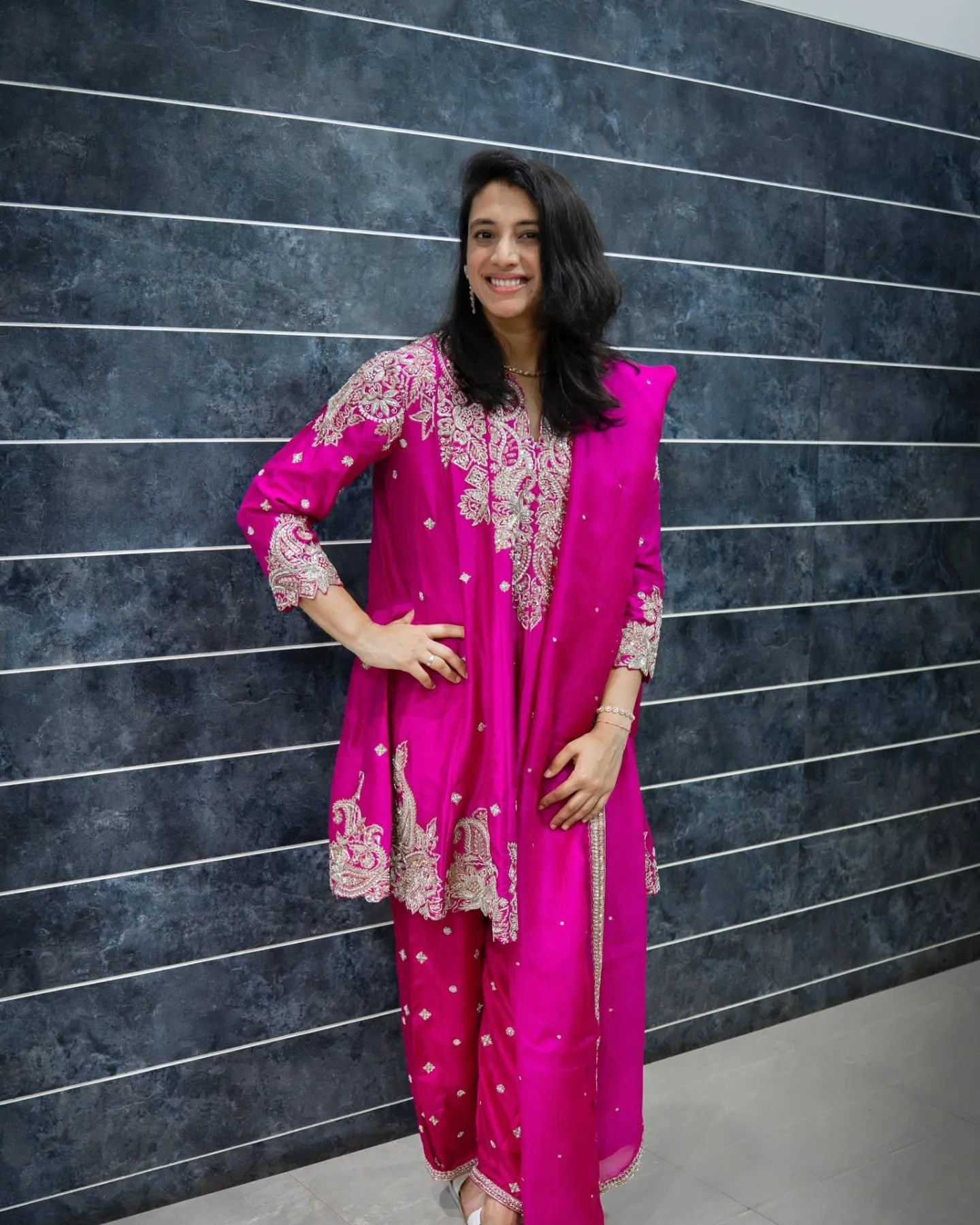 Smriti dressed in bright pink traditional Indian outfit