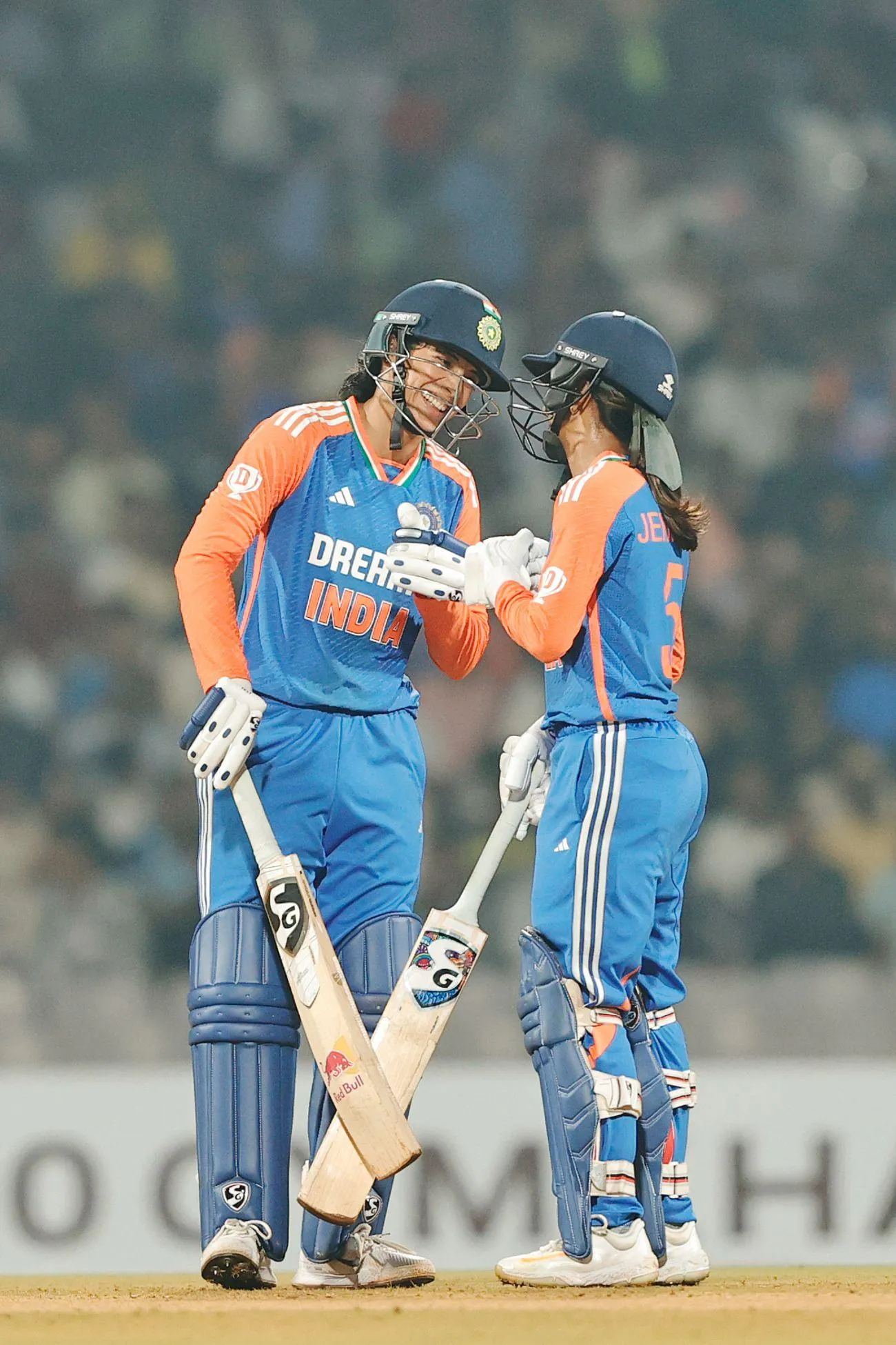 Smriti hugging teammate in blue jersey after match