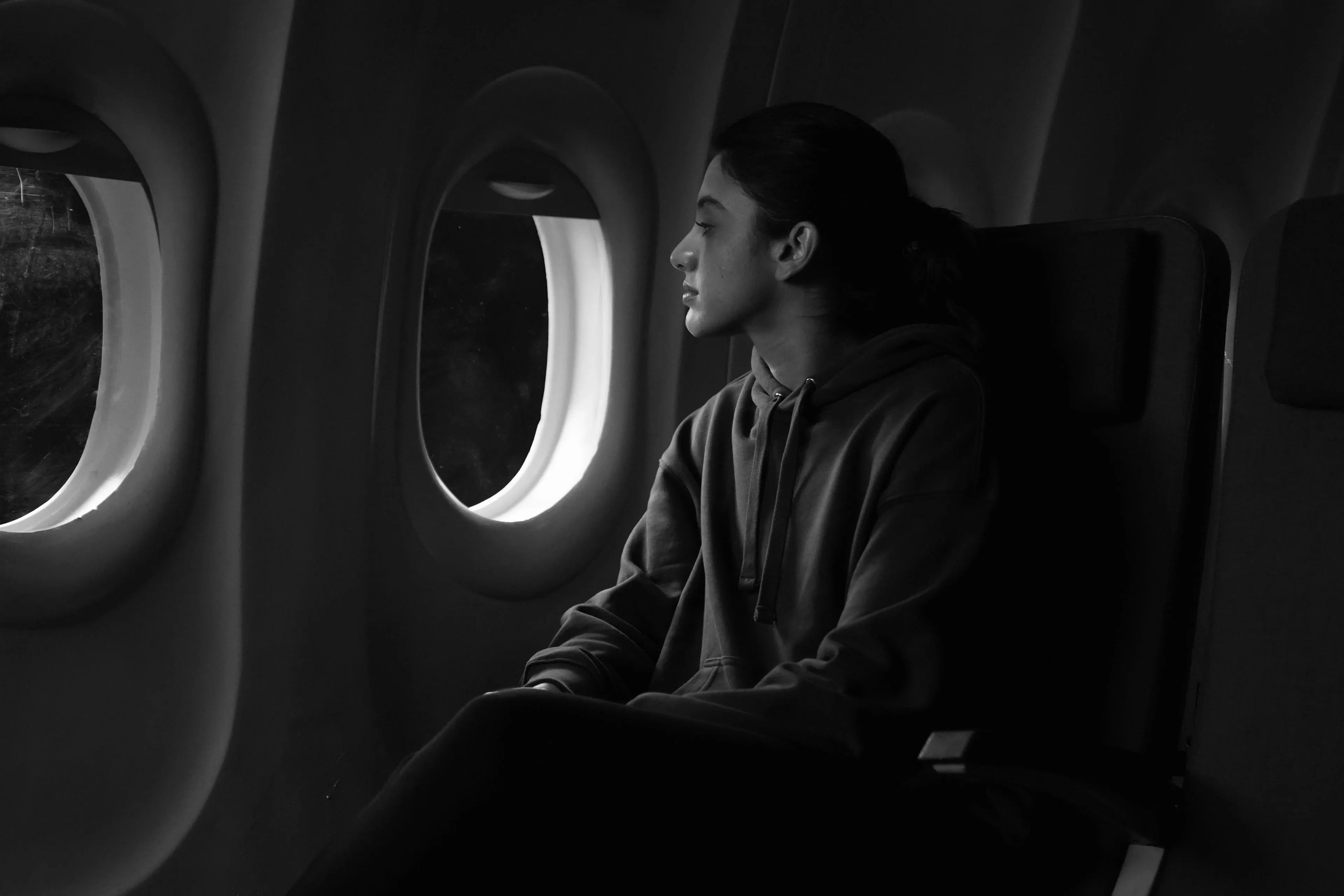 Smriti looking out airplane window from inside the cabin