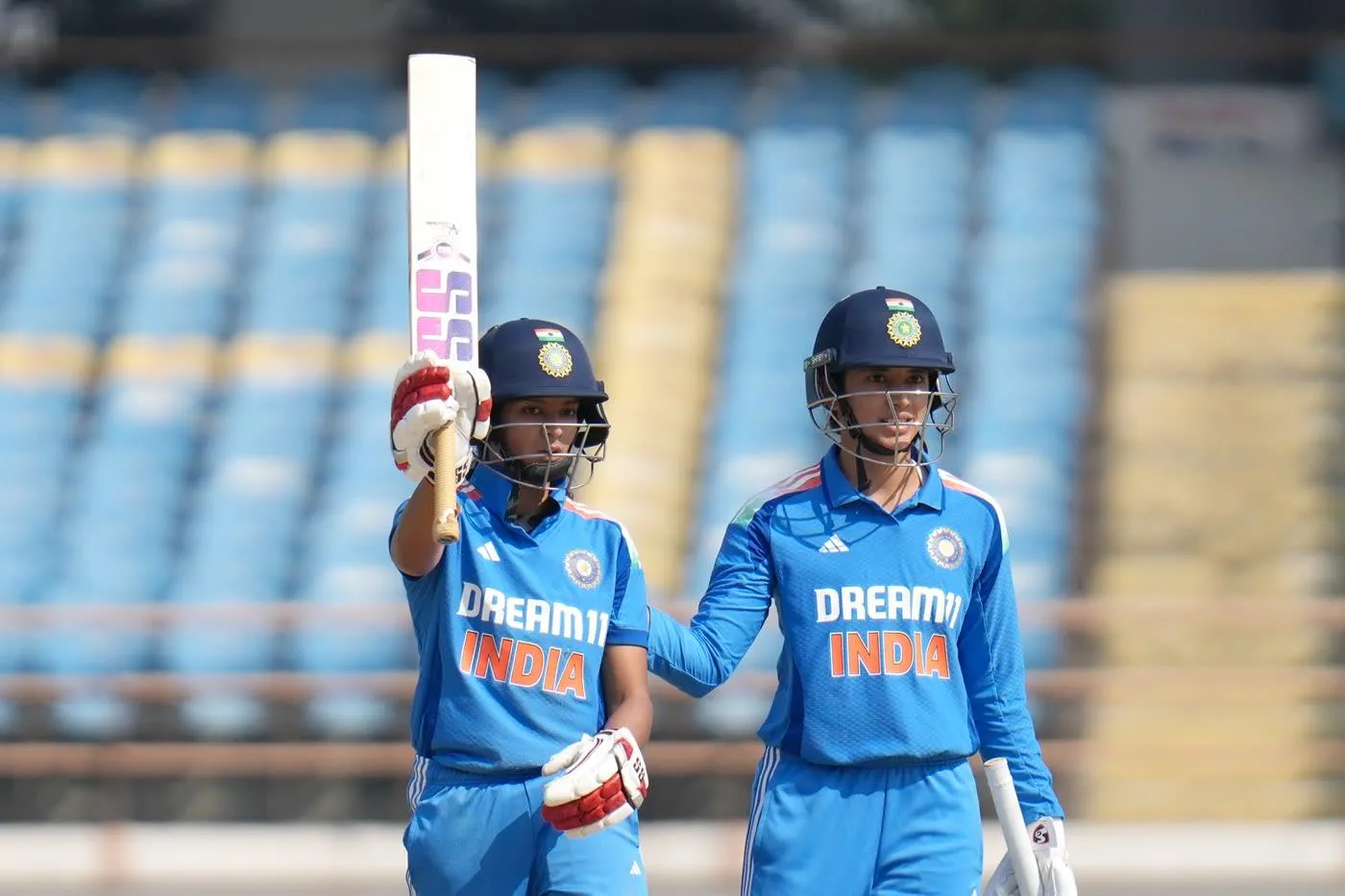 Smriti Mandhana and teammate celebrating partnership on field