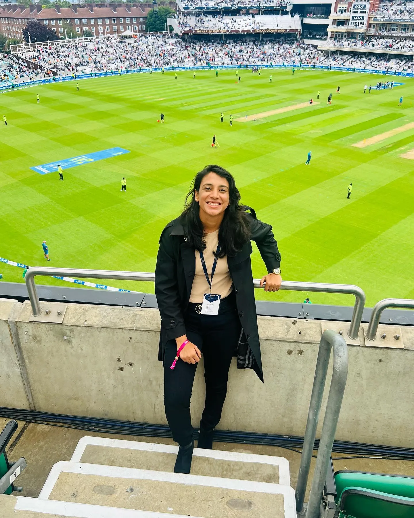 Smriti Mandhana at stadium balcony with green field view
