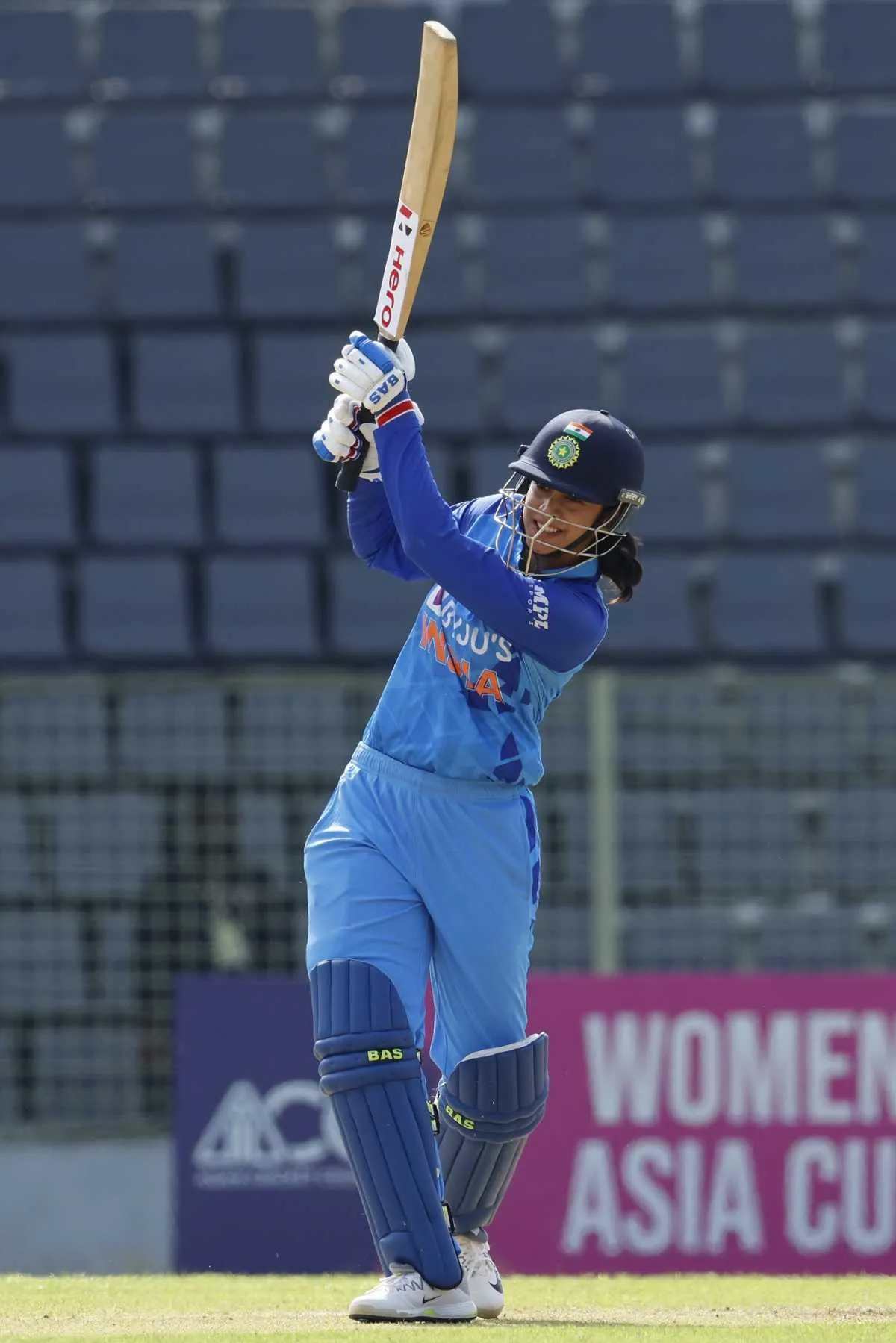 Smriti Mandhana batting and focused on the ball during a match