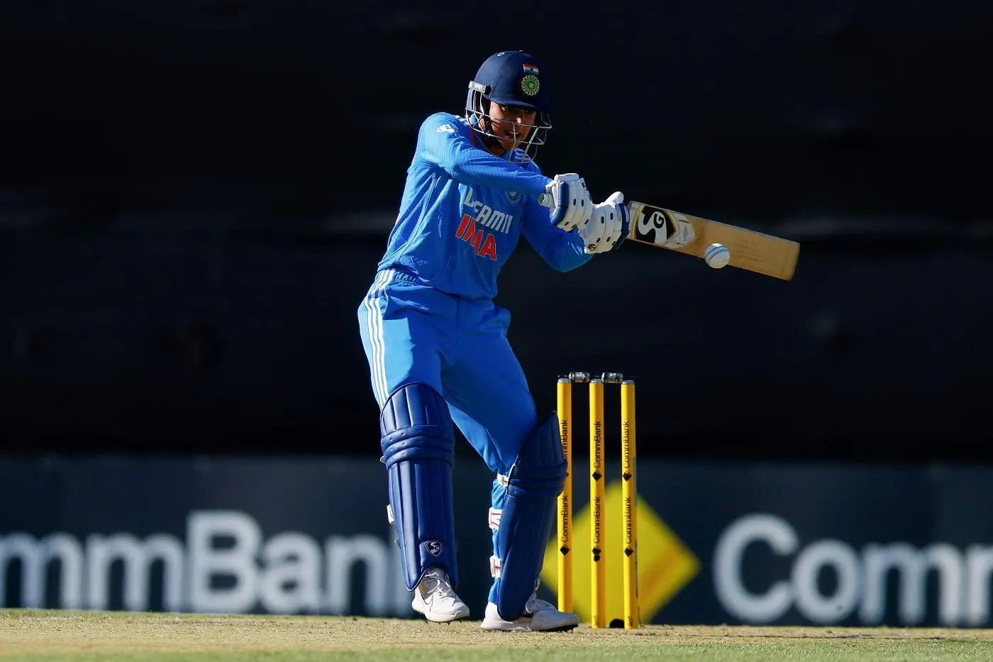 Smriti Mandhana Batting During a Night Cricket Match wallpaper