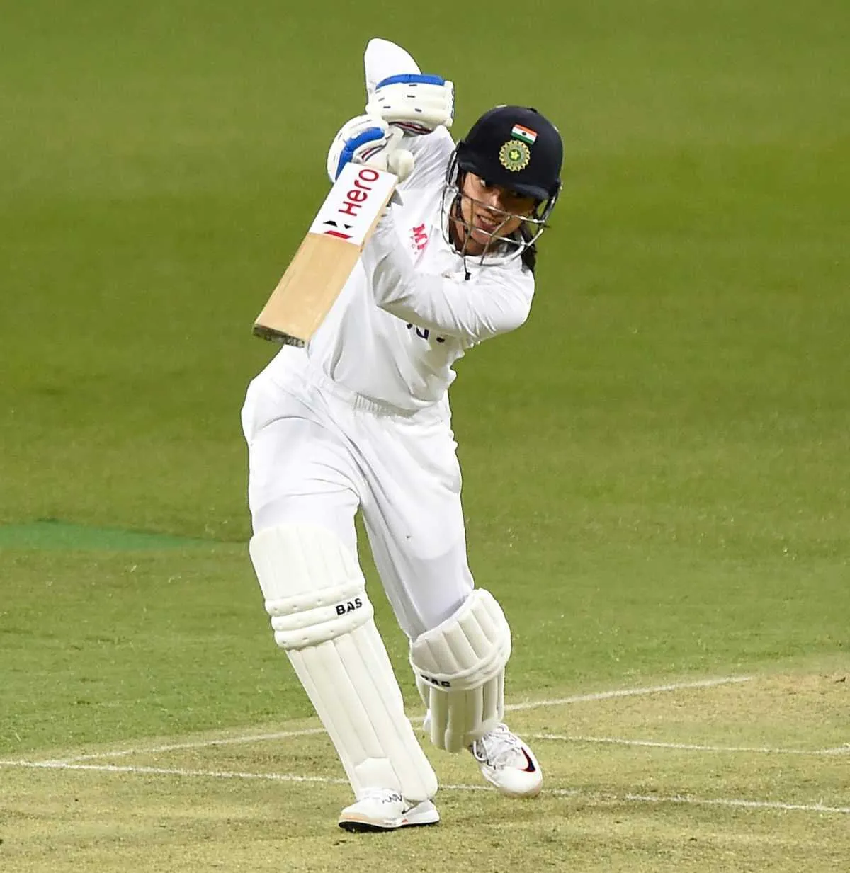 Smriti Mandhana bowling during a cricket match wallpaper