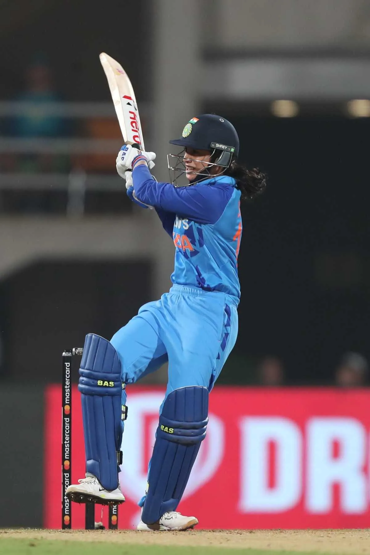 Smriti Mandhana bowling with focus during a cricket match