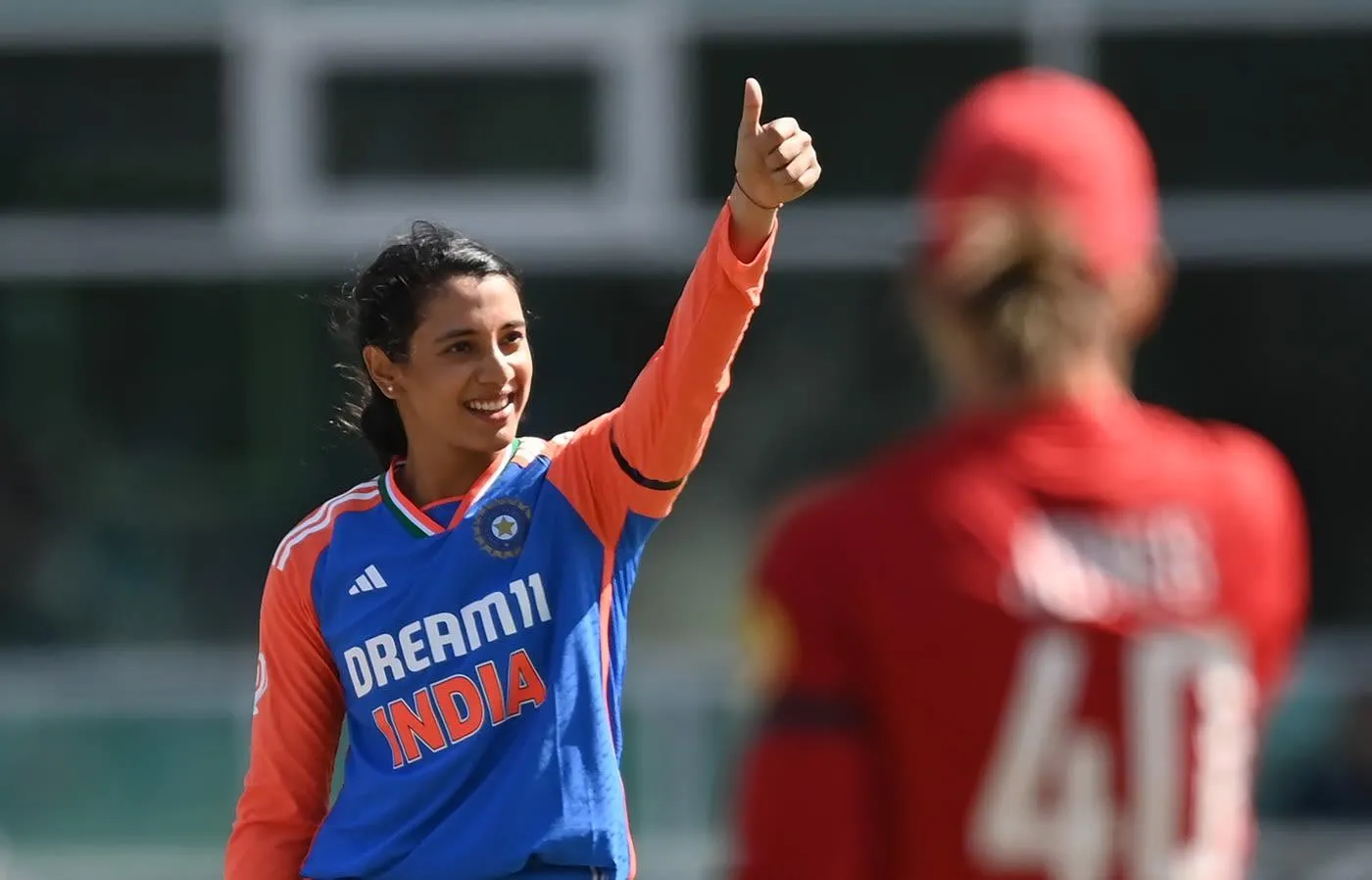 Smriti Mandhana celebrating win with raised hand wallpaper