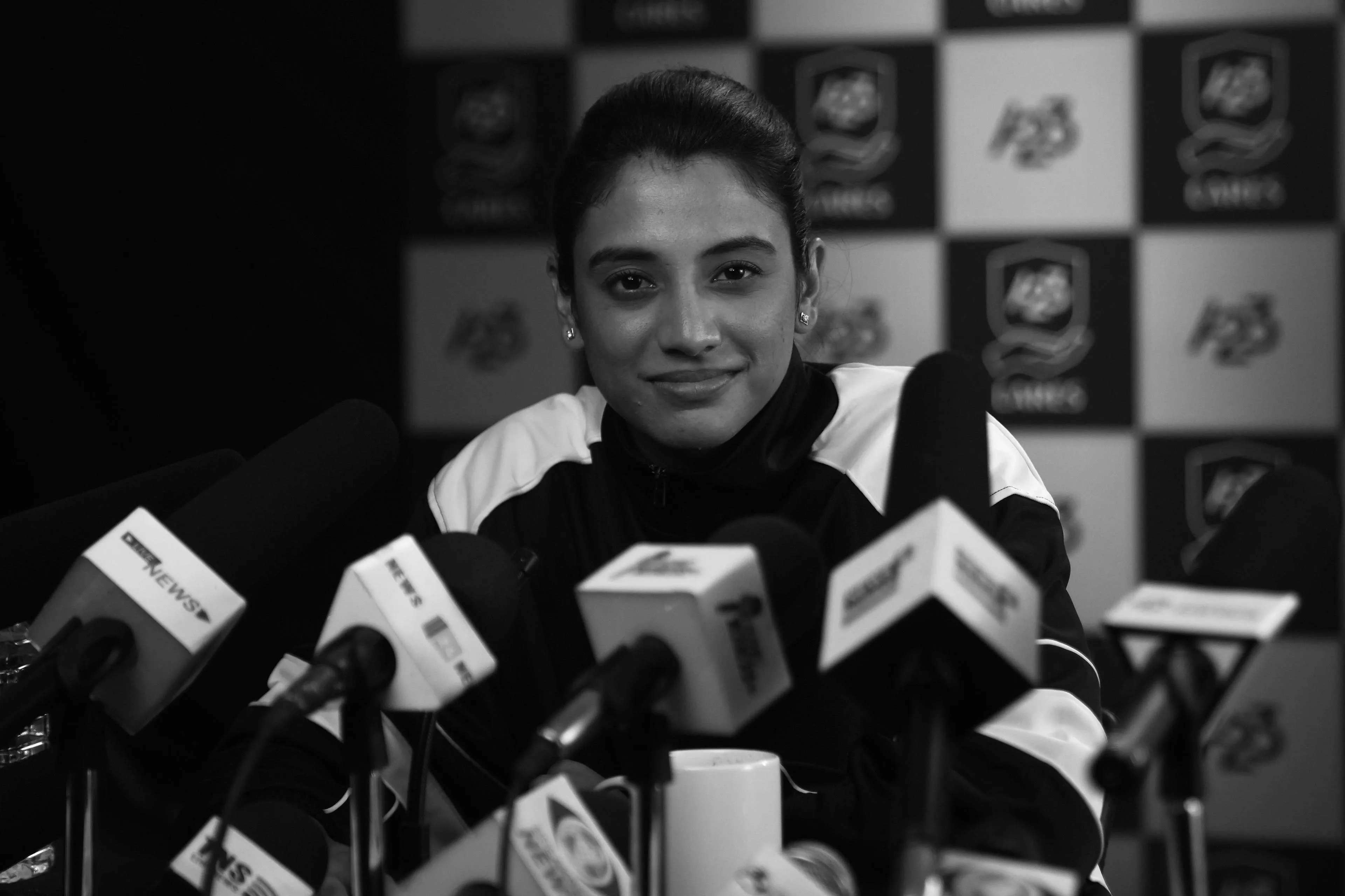 Smriti Mandhana during a press meet in black and white setting