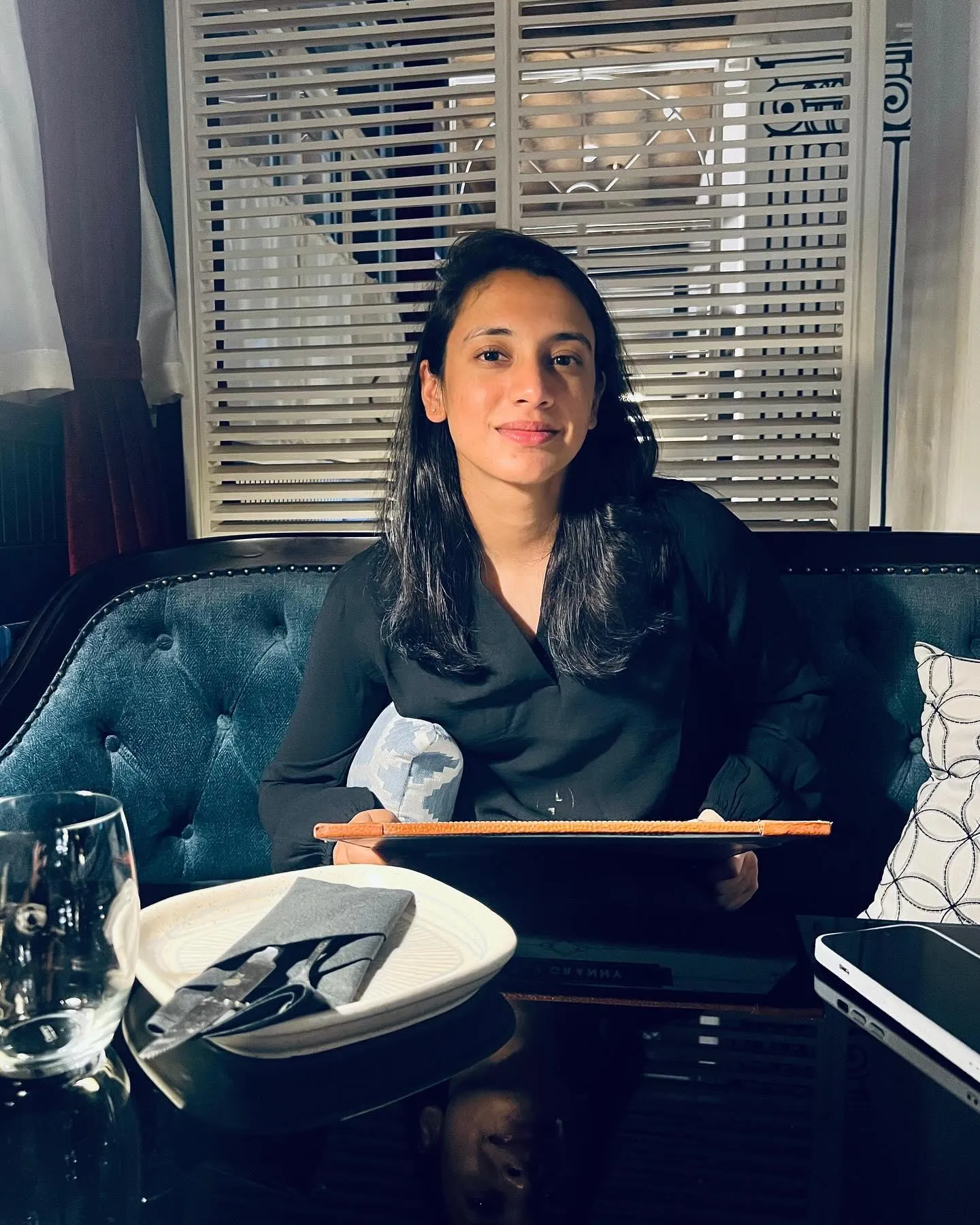 Smriti Mandhana enjoying a meal in cozy restaurant setting