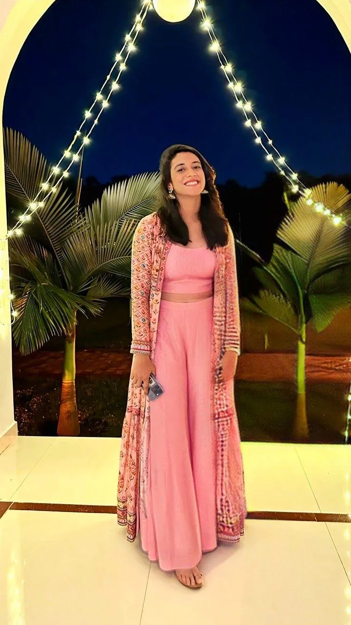 Smriti Mandhana event in a pink dress posing for the camera