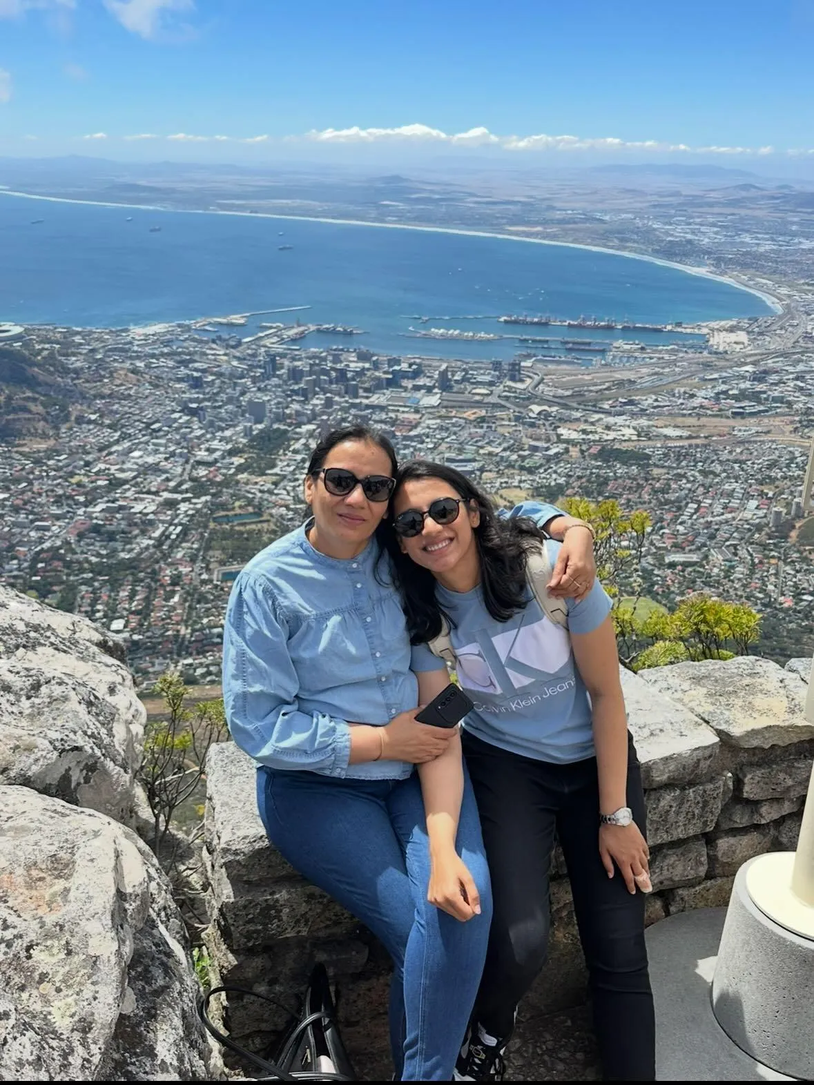 Smriti Mandhana friend posing in front of a scenic landscape