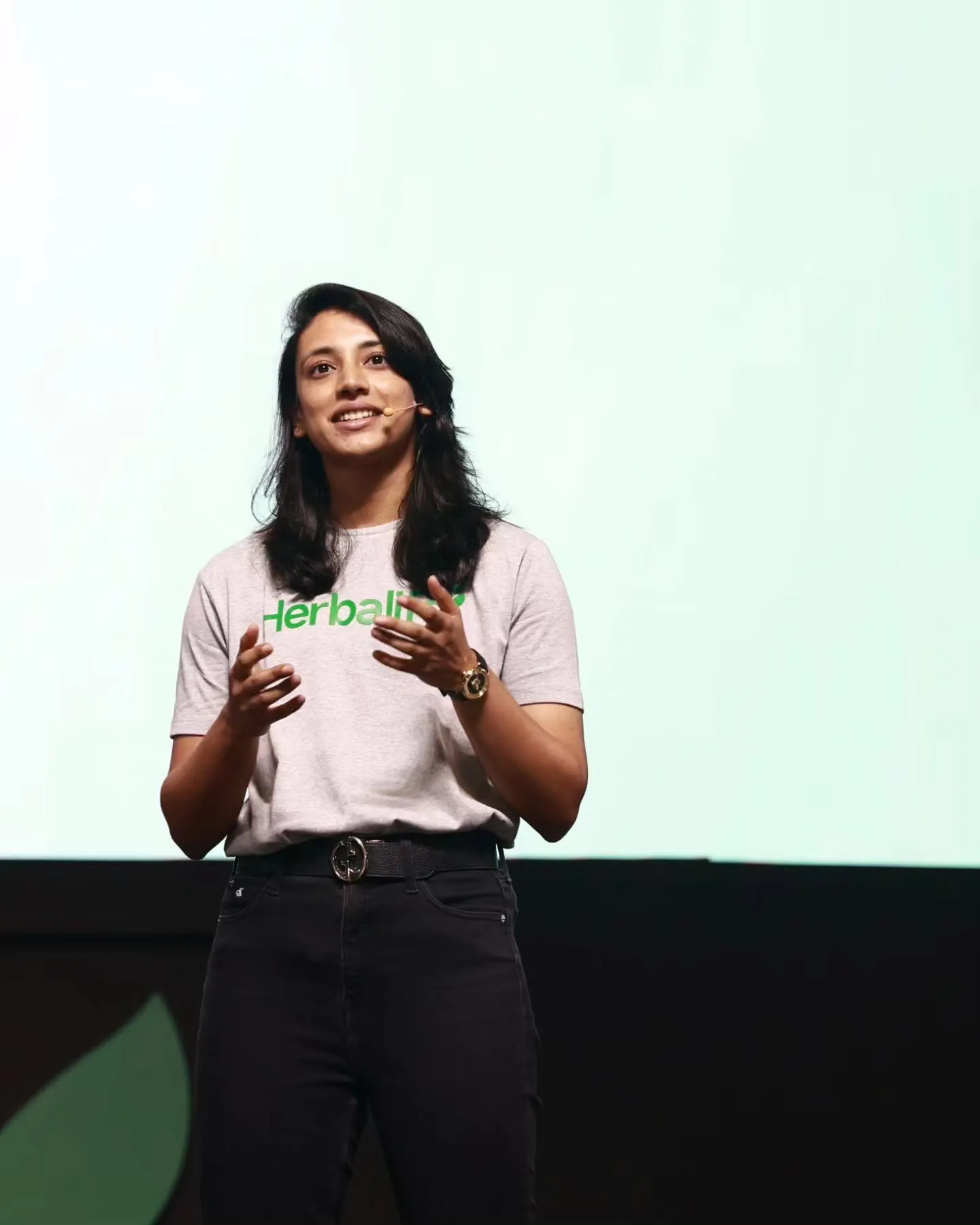 Smriti Mandhana Giving a Talk on Stage in White Top