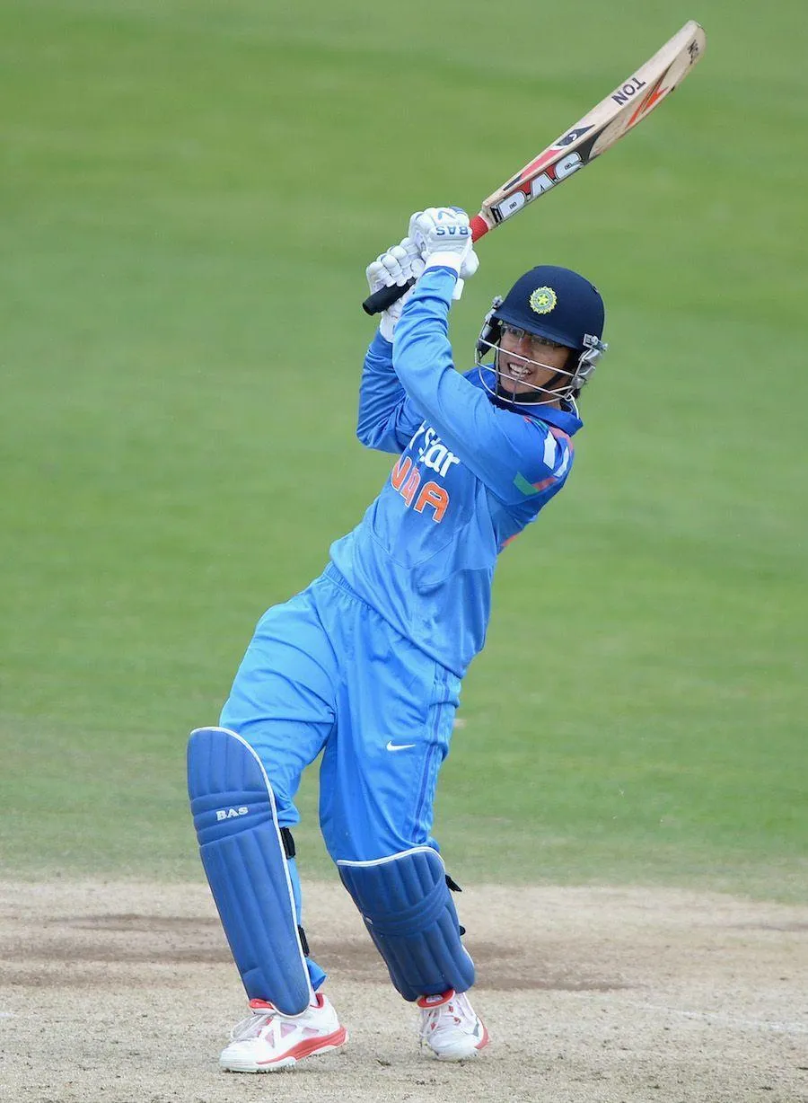Smriti Mandhana hitting a powerful cricket shot during a match