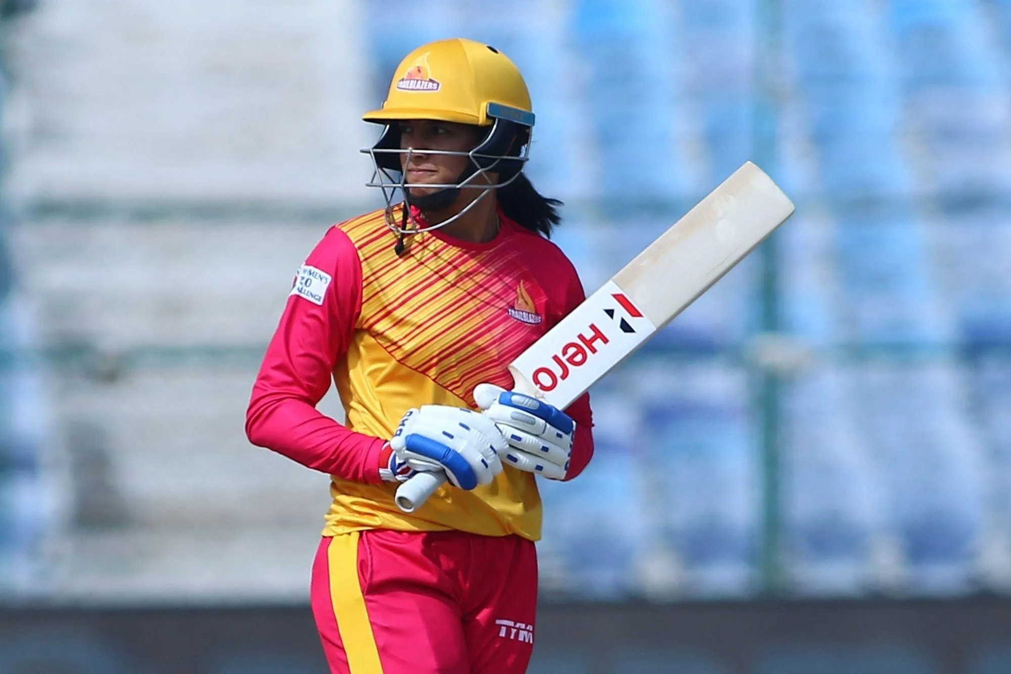 Smriti Mandhana hitting a powerful shot in a match