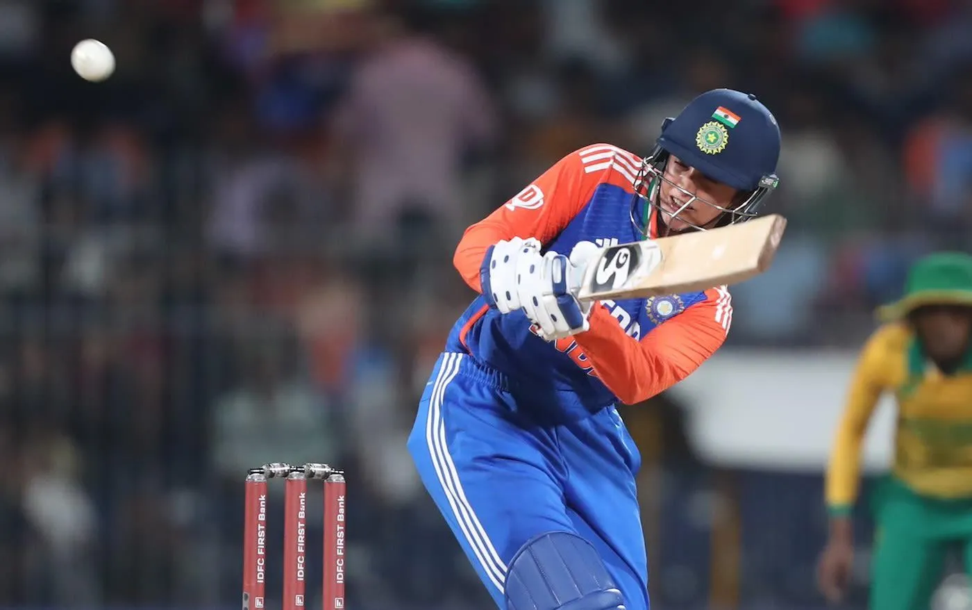 Smriti Mandhana hitting a shot in a cricket match wallpaper