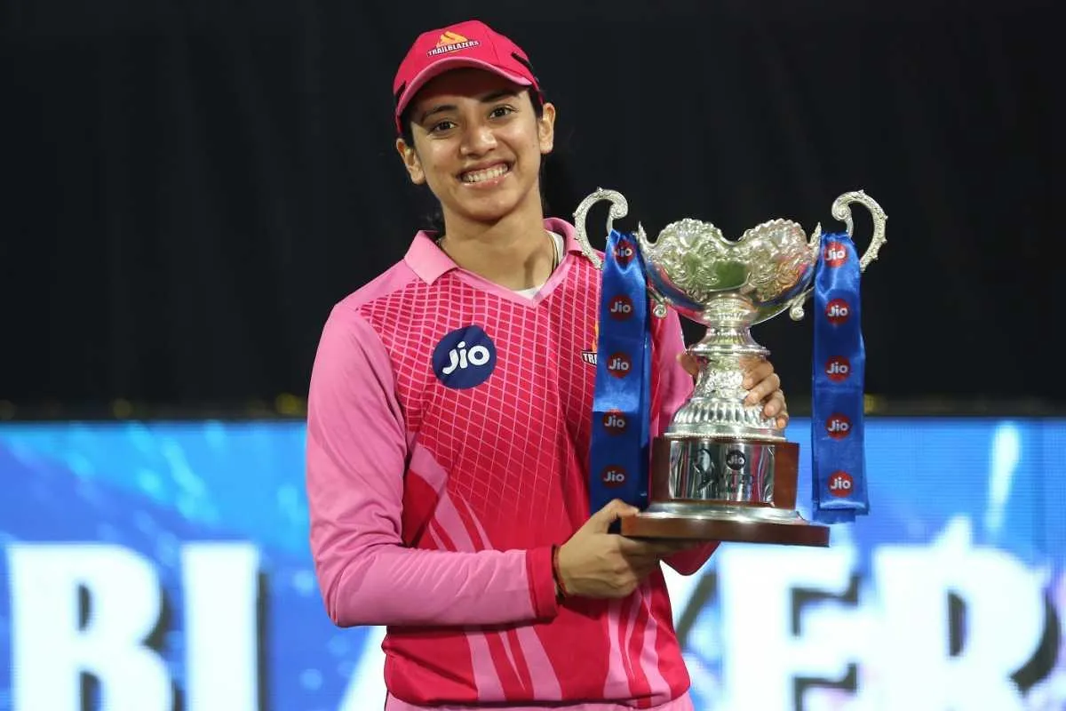 Smriti Mandhana holding a trophy after a win wallpaper