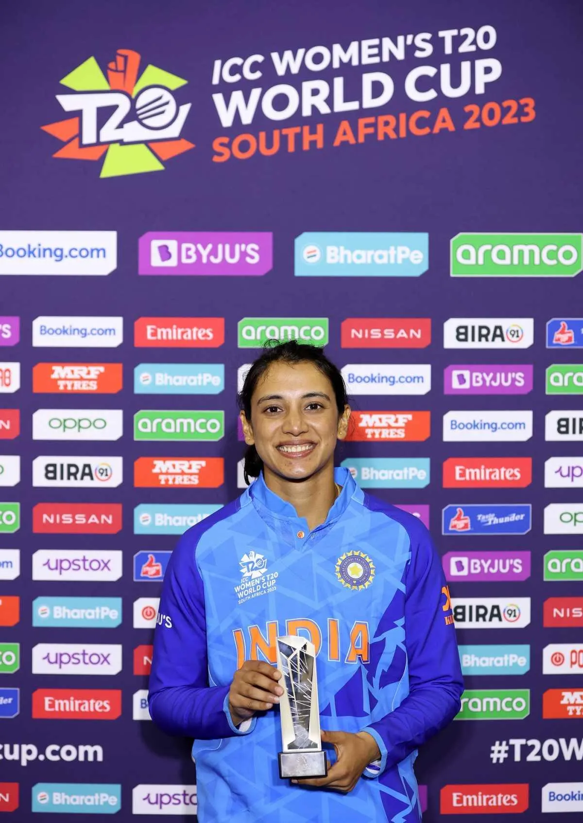 Smriti Mandhana holding an award after a great performance