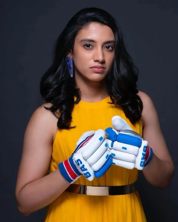 Smriti Mandhana Holding Cricket Gloves in Yellow Jersey