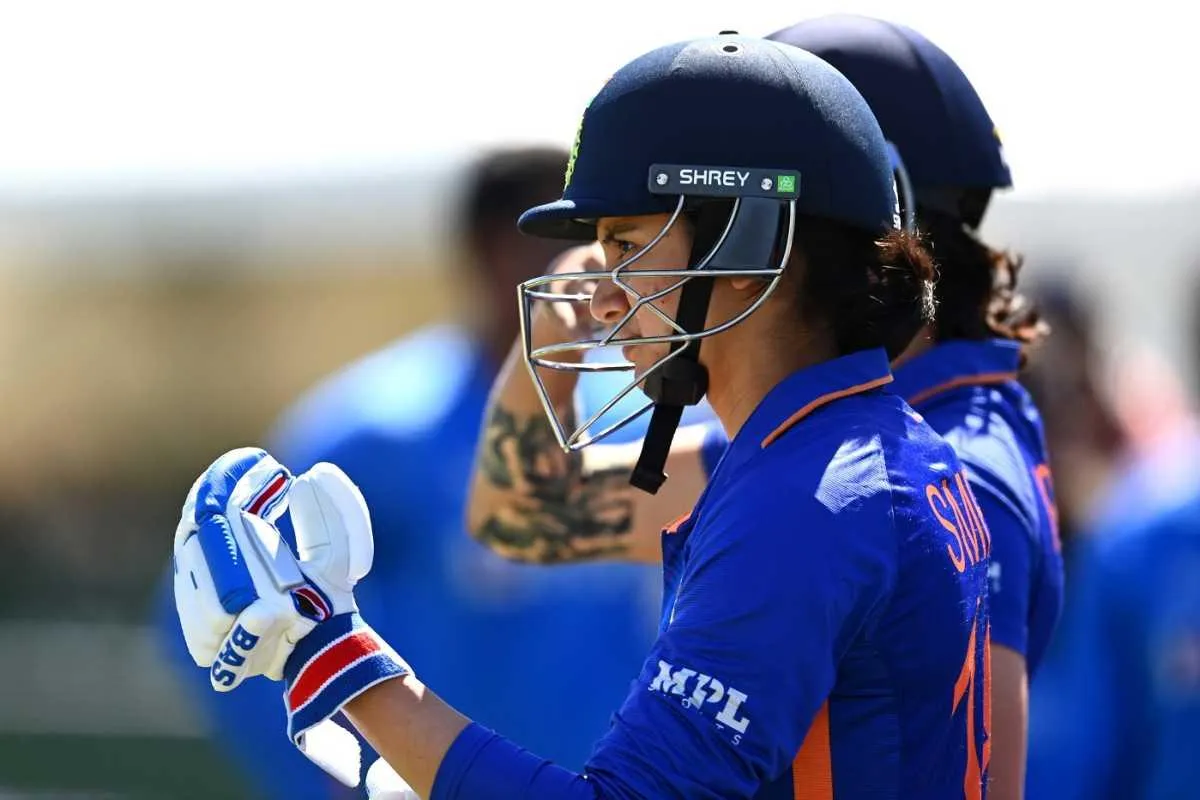 Smriti Mandhana holding helmet and bat after match