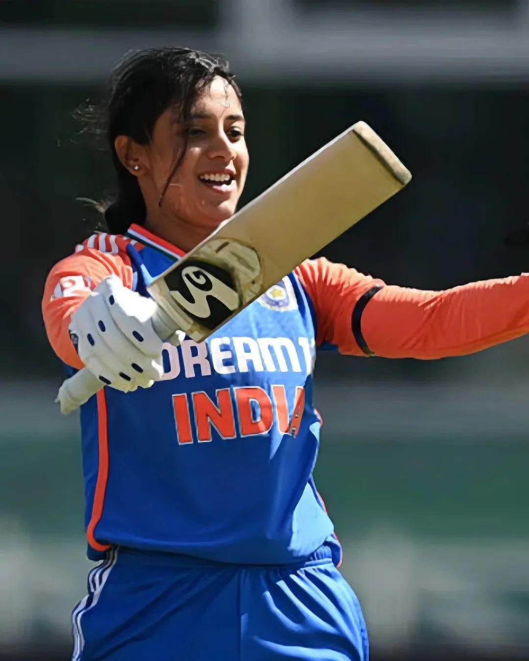 Smriti Mandhana holding her bat during a cricket match