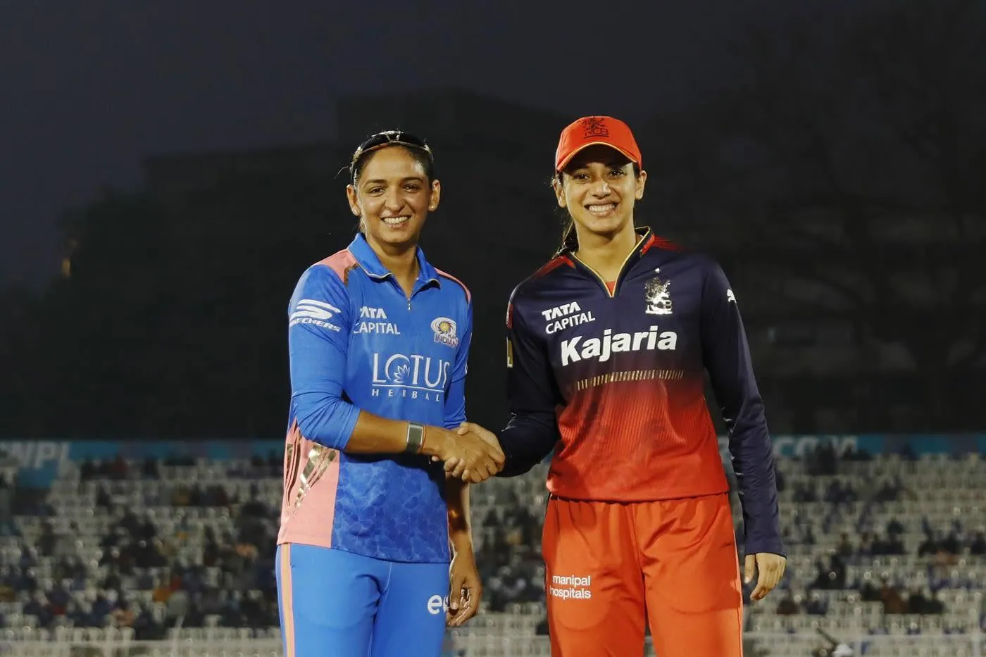Smriti Mandhana in a team photo with teammates on the field