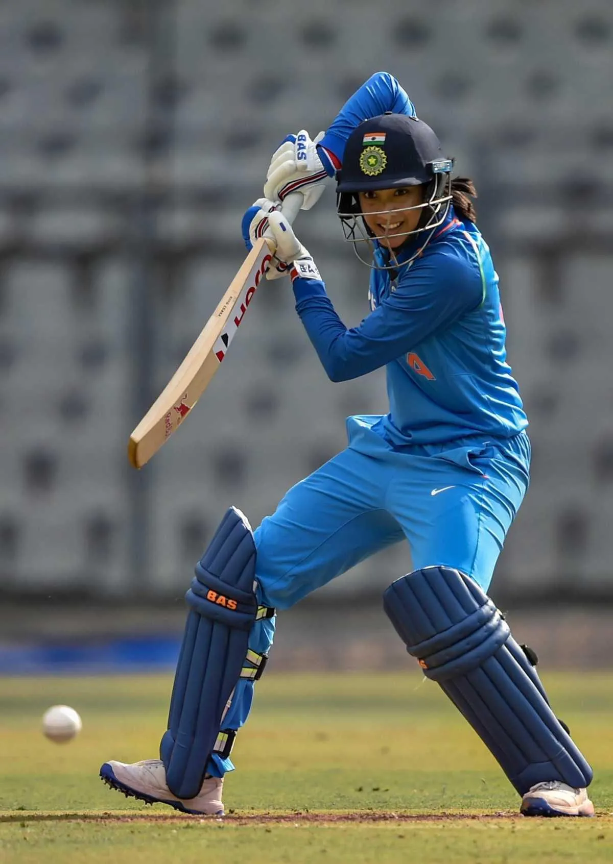 Smriti Mandhana in action playing cricket on the field