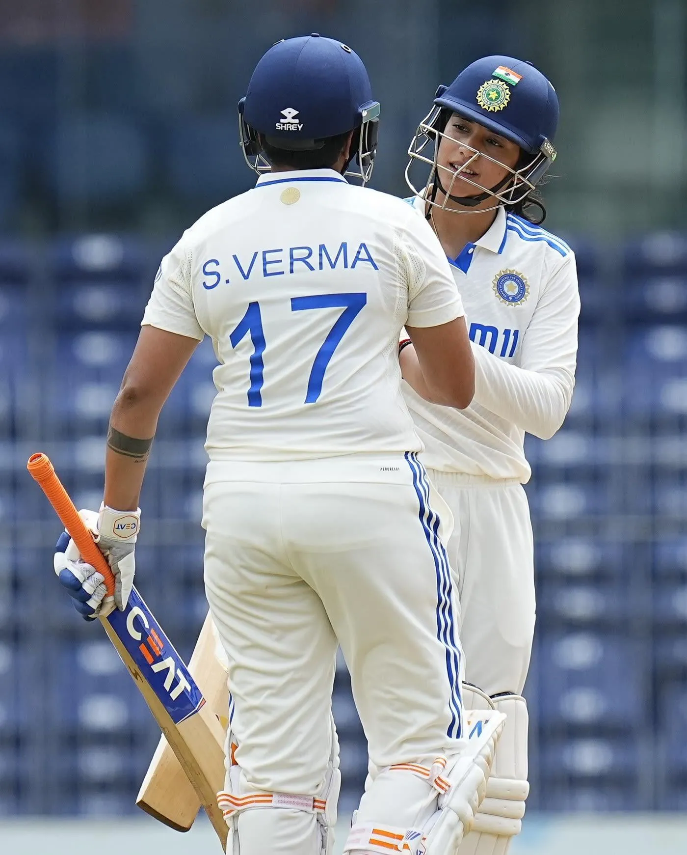 Smriti Mandhana in Action with Fellow Cricketers wallpaper