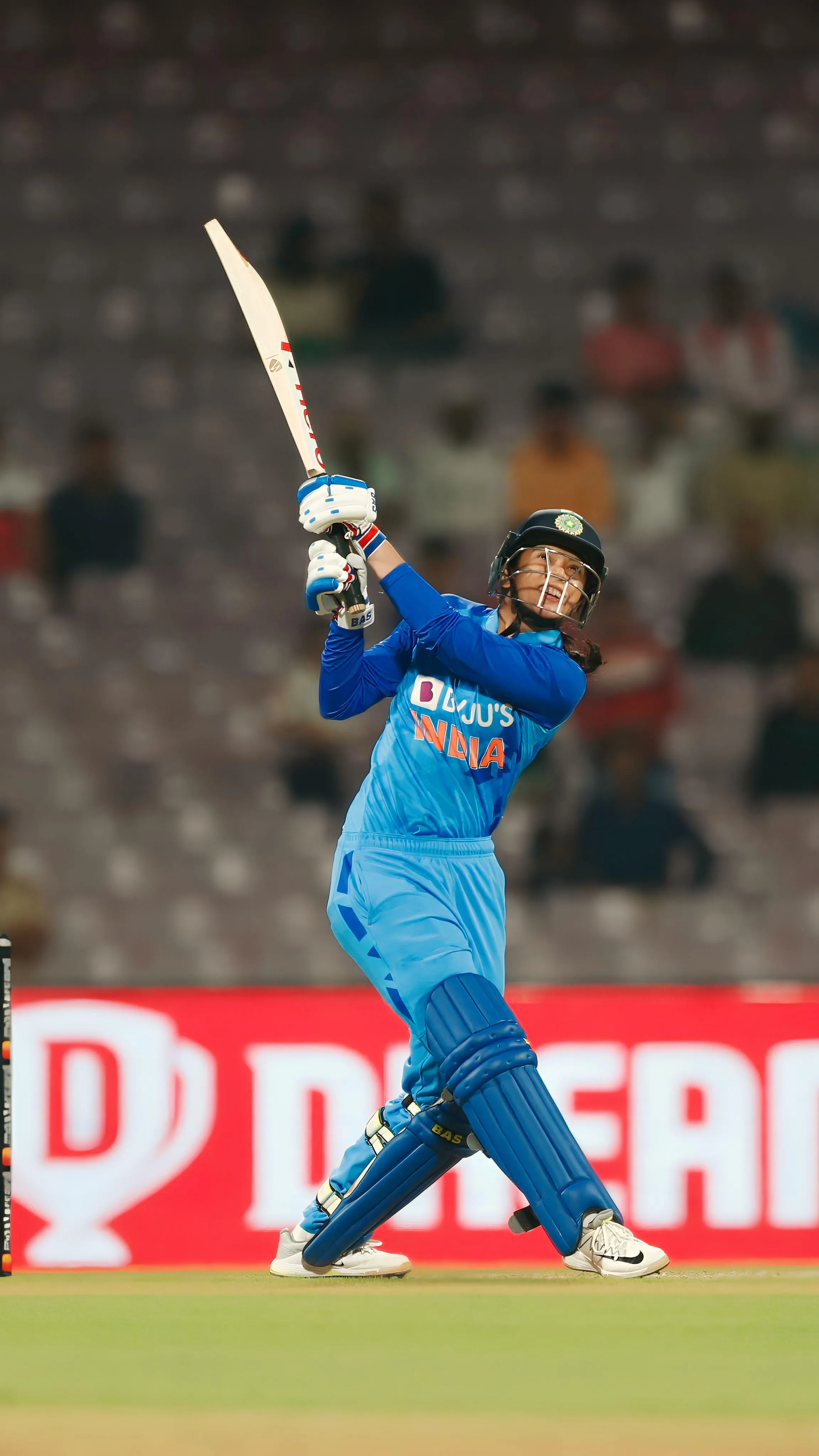 Smriti Mandhana in blue India jersey playing a cricket shot