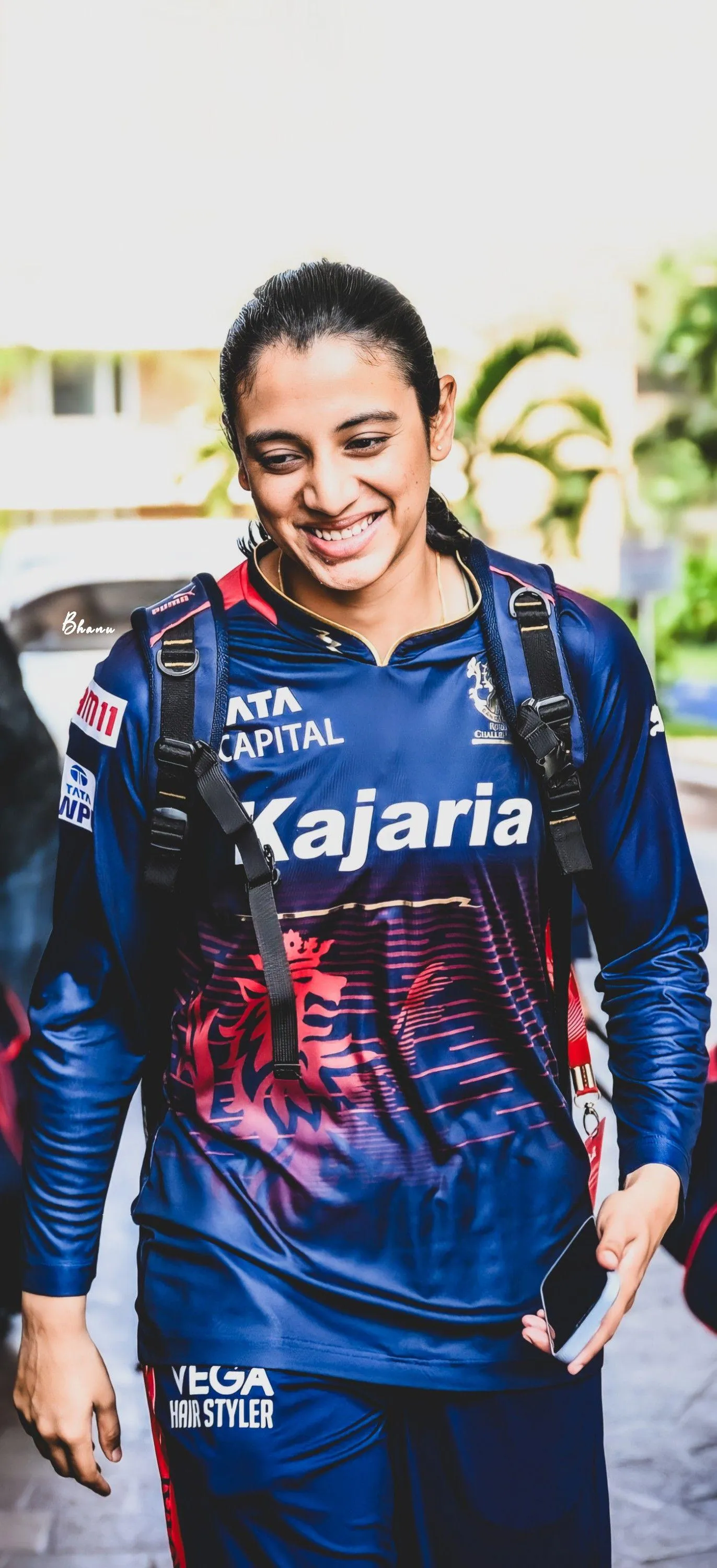 Smriti Mandhana in blue jersey smiling indoors wallpaper