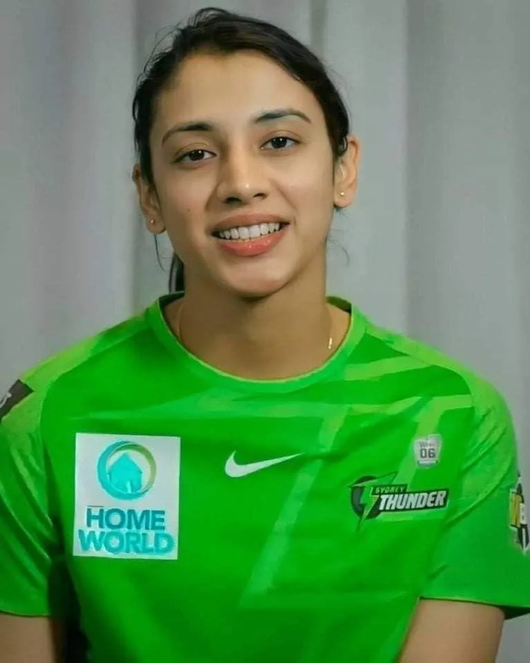 Smriti Mandhana in Green Jersey with a Smiling Pose