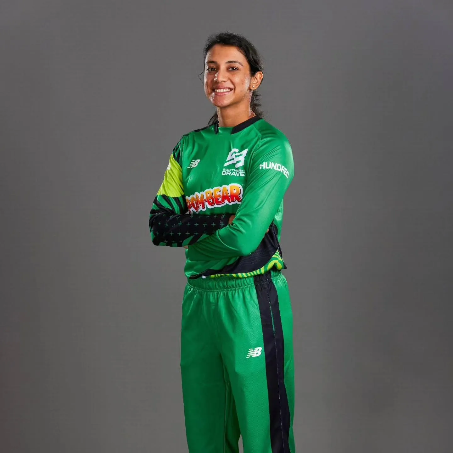 Smriti Mandhana in Green Suit Posing Confidently wallpaper
