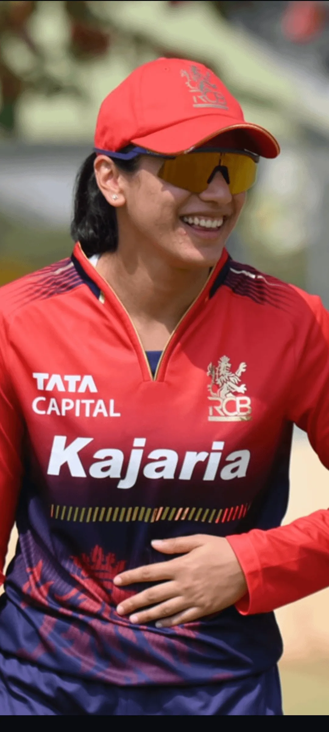 Smriti Mandhana in Kajaria jersey and cap during a match