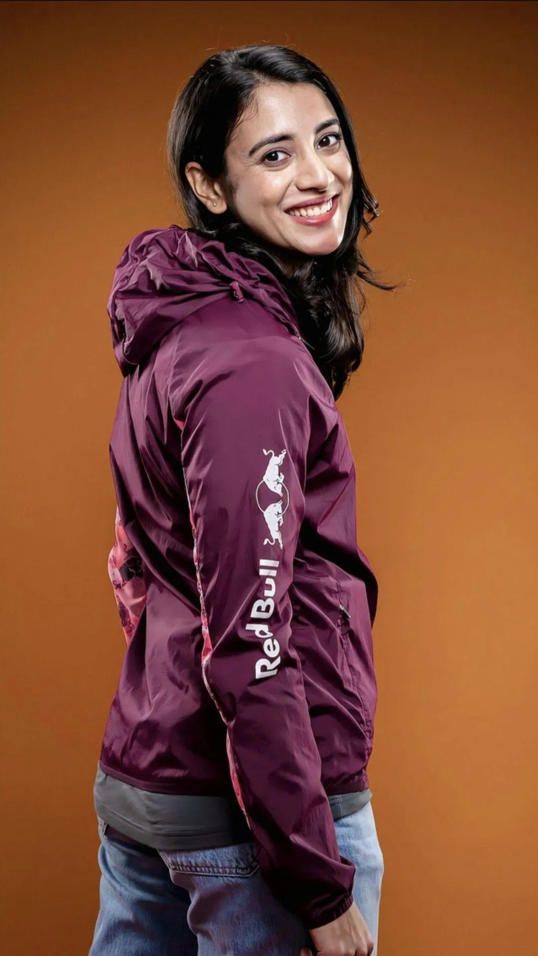 Smriti Mandhana in maroon kit celebrating a milestone