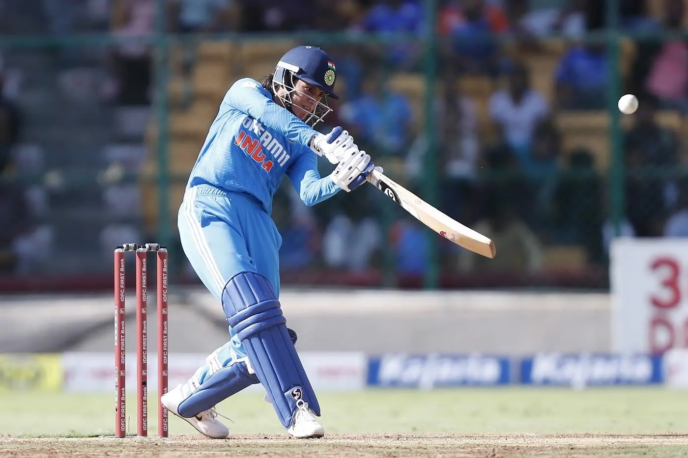 Smriti Mandhana in midaction bowling a delivery in cricket