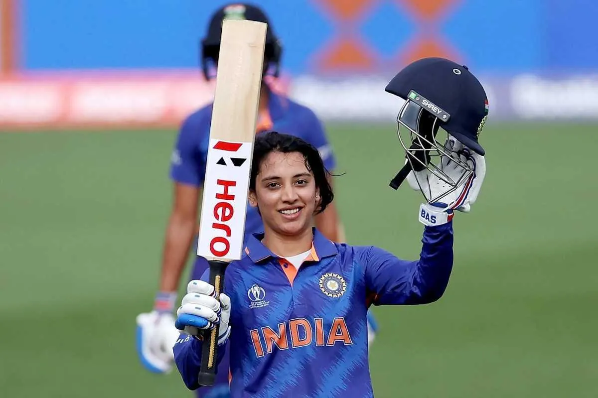 Smriti Mandhana lifting bat after scoring in a match