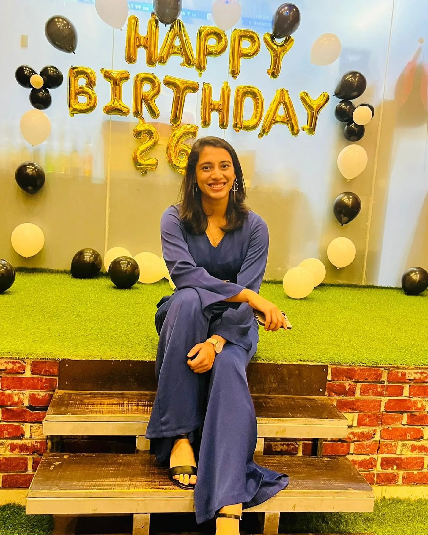 Smriti Mandhana near birthday banner and festive balloons