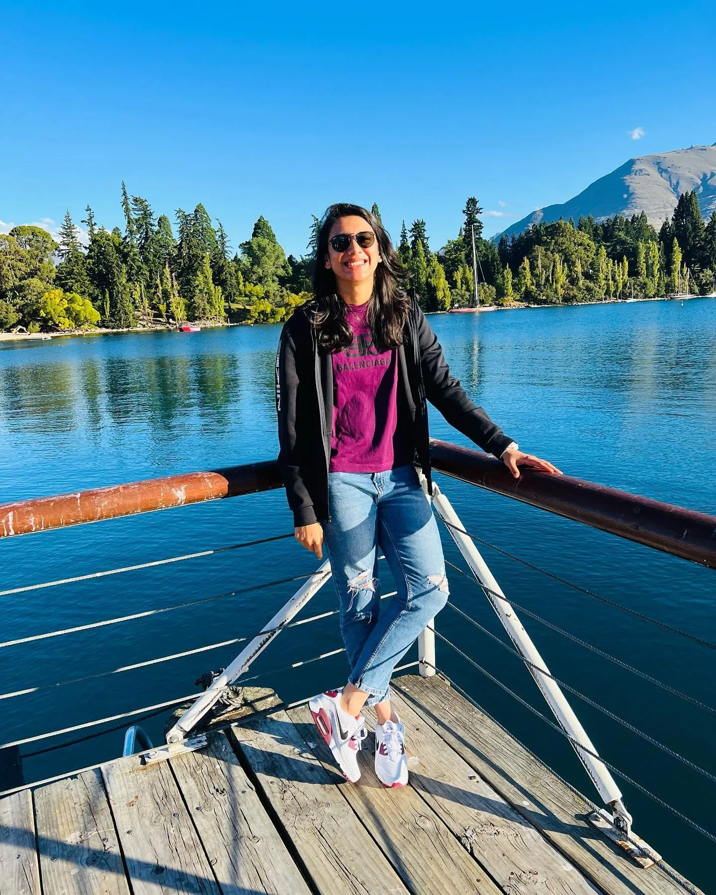 Smriti Mandhana on boat deck posing near calm blue waters
