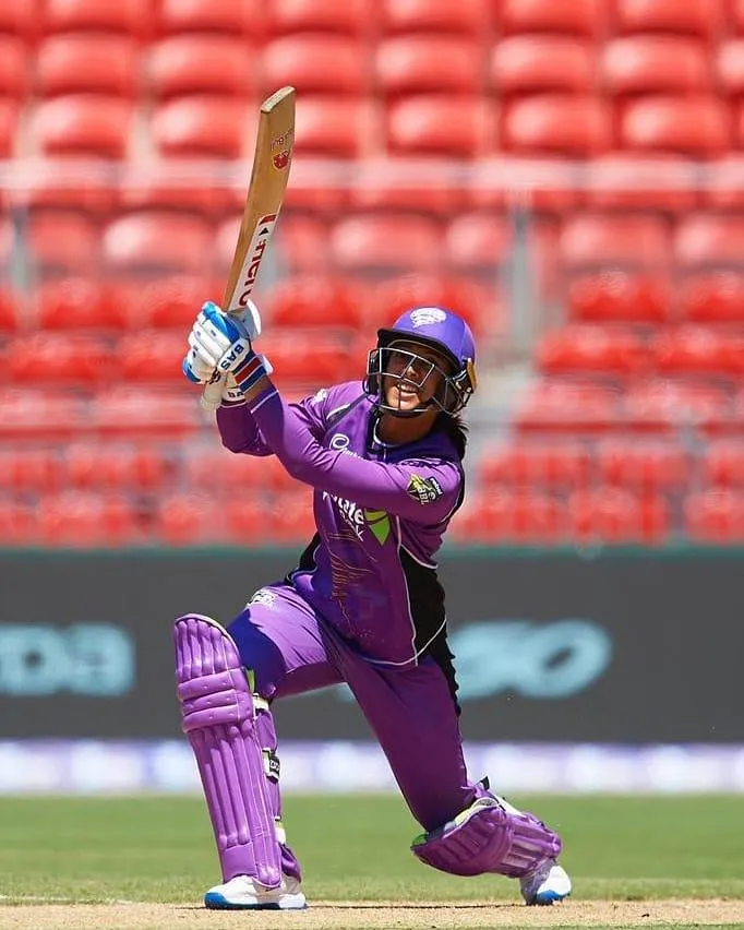 Smriti Mandhana Playing a Pull Shot in Purple Kit wallpaper