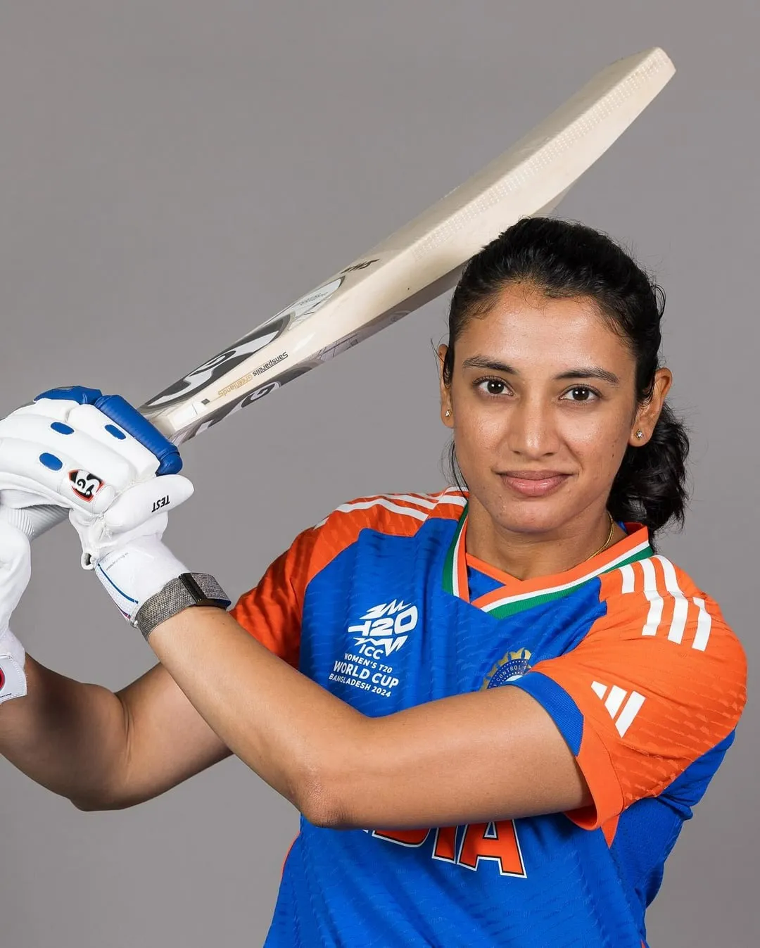 Smriti Mandhana playing a shot in a crucial game wallpaper