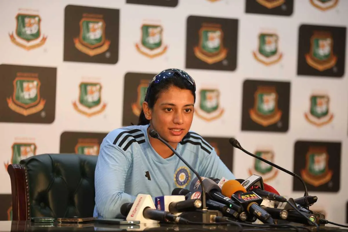 Smriti Mandhana posing at a press event wallpaper