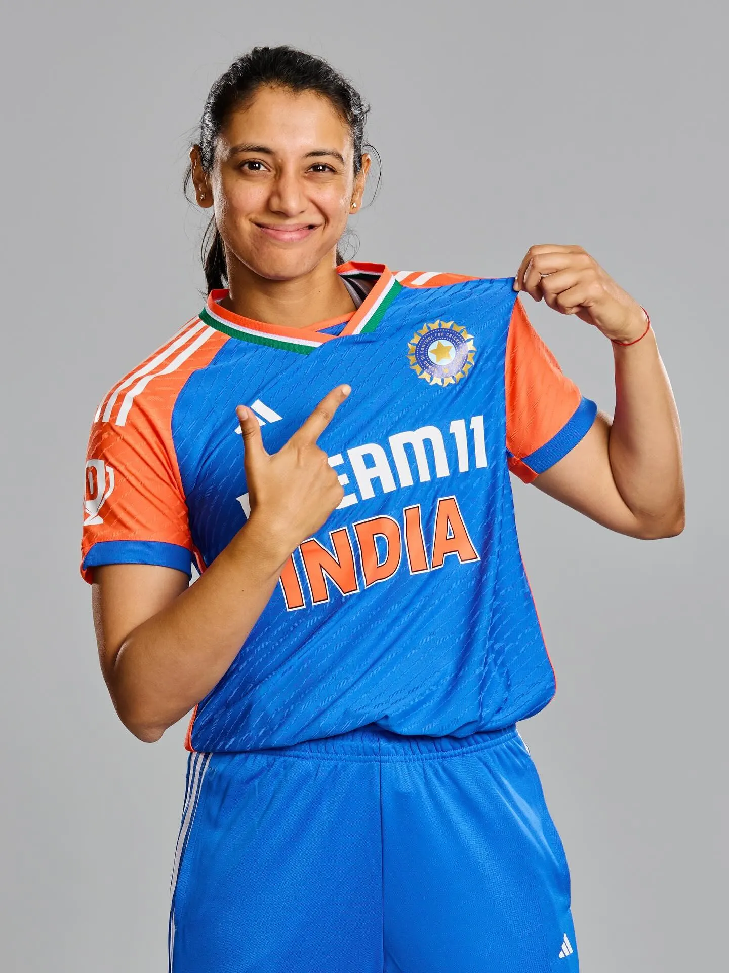 Smriti Mandhana posing confidently India cricket jersey