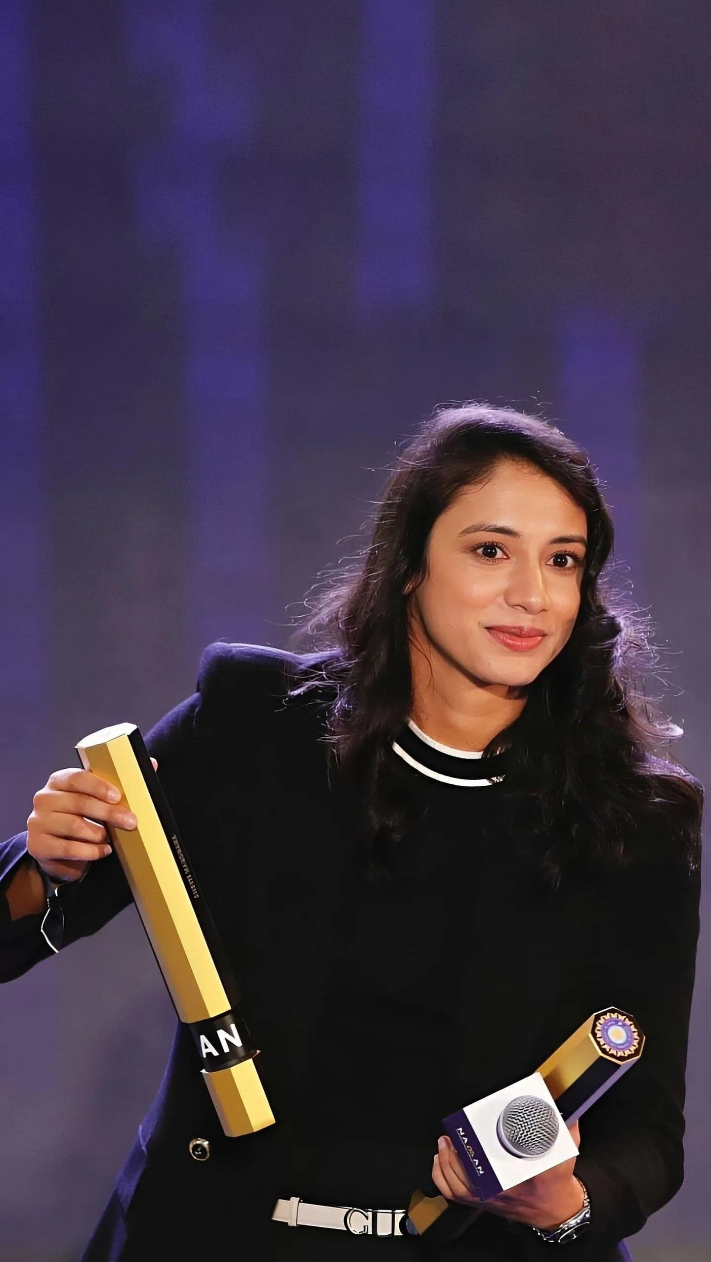 Smriti Mandhana Posing Confidently with Cricket Award