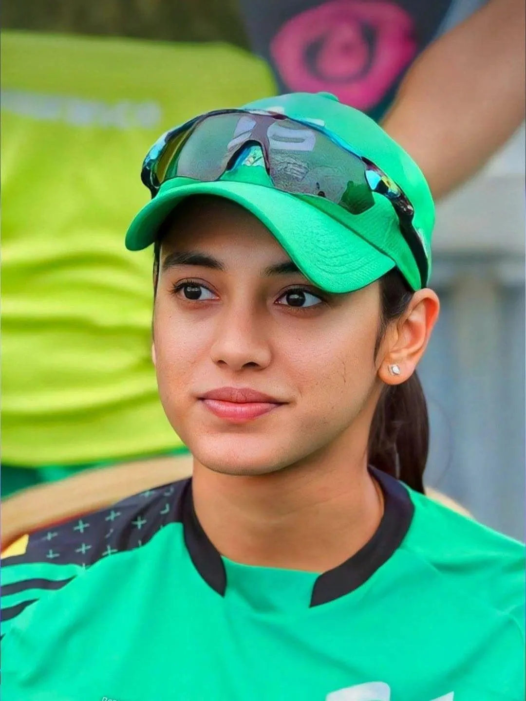 Smriti Mandhana posing in a green jersey for a casual picture