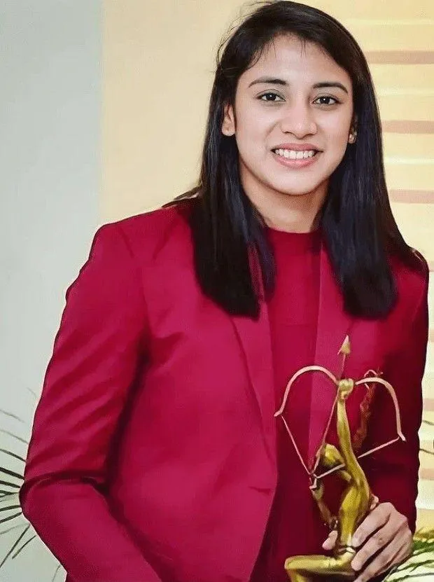 Smriti Mandhana Posing in Red Blazer with Award wallpaper