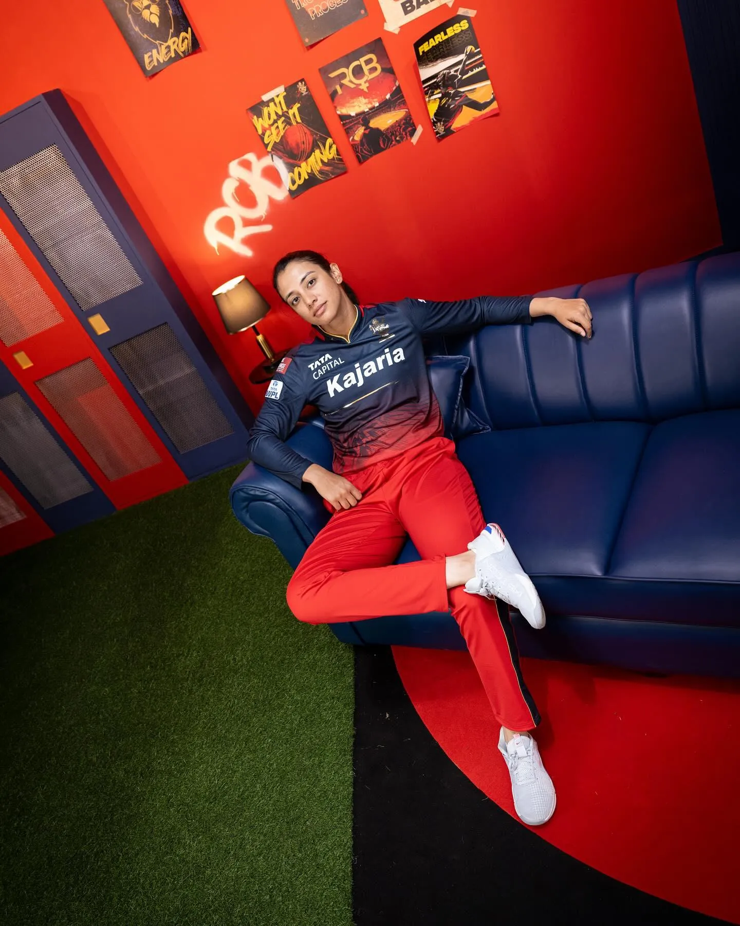 Smriti Mandhana posing next to a large stuffed red dragon