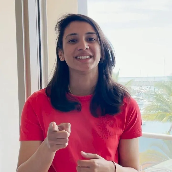 Smriti Mandhana Posing with a Phone in Hand wallpaper